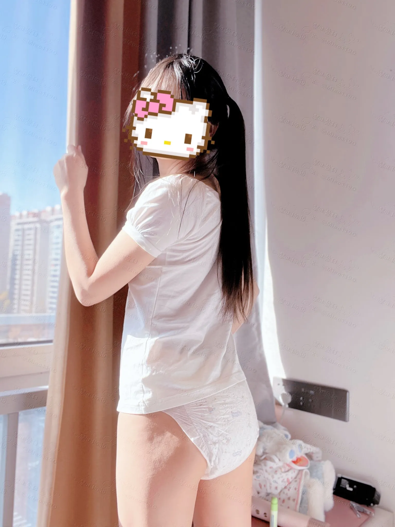 A girl in diapers basking in the sunlight streaming through the window