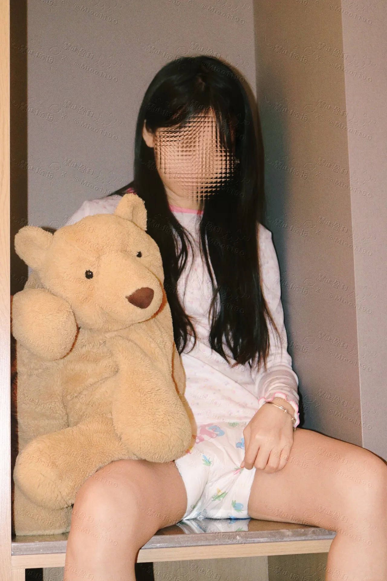An ABDL girl hugging a teddy bear and wearing paper diapers