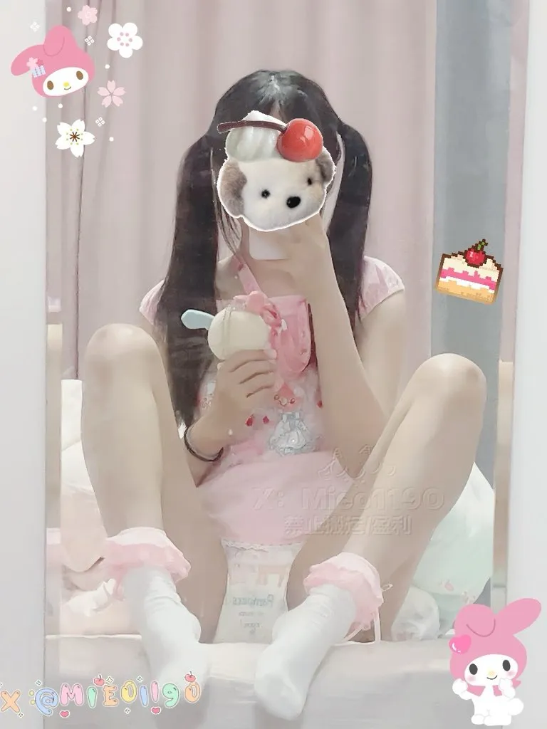 An ABDL girl wearing pink babyish clothes and showing off her diaper