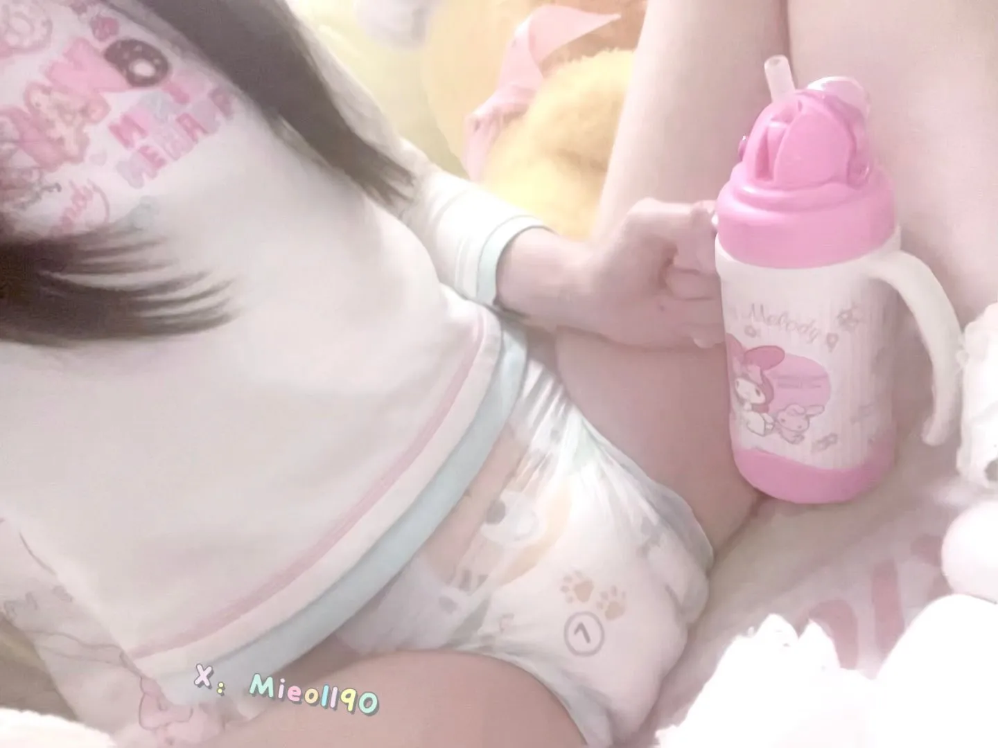 An ABDL girl holding a baby bottle and wearing Pampers diapers