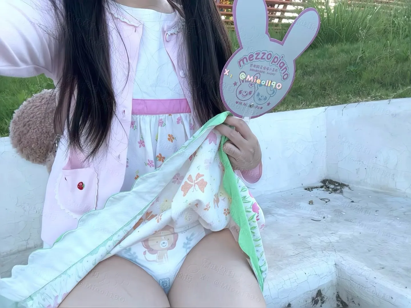 An ABDL girl lifting her skirt outdoors to show off her diaper