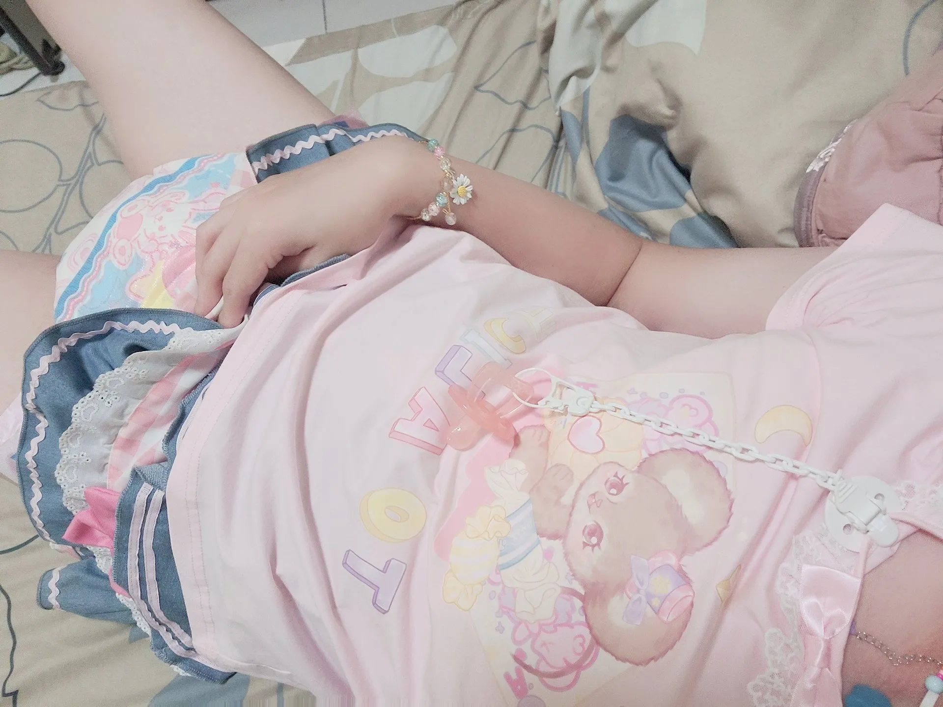 ABDL girl lying down, lifting her skirt to show off her diaper