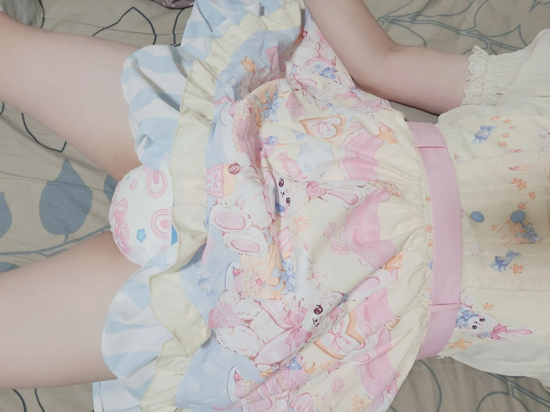 An ABDL girl wearing a cute dress and diapers