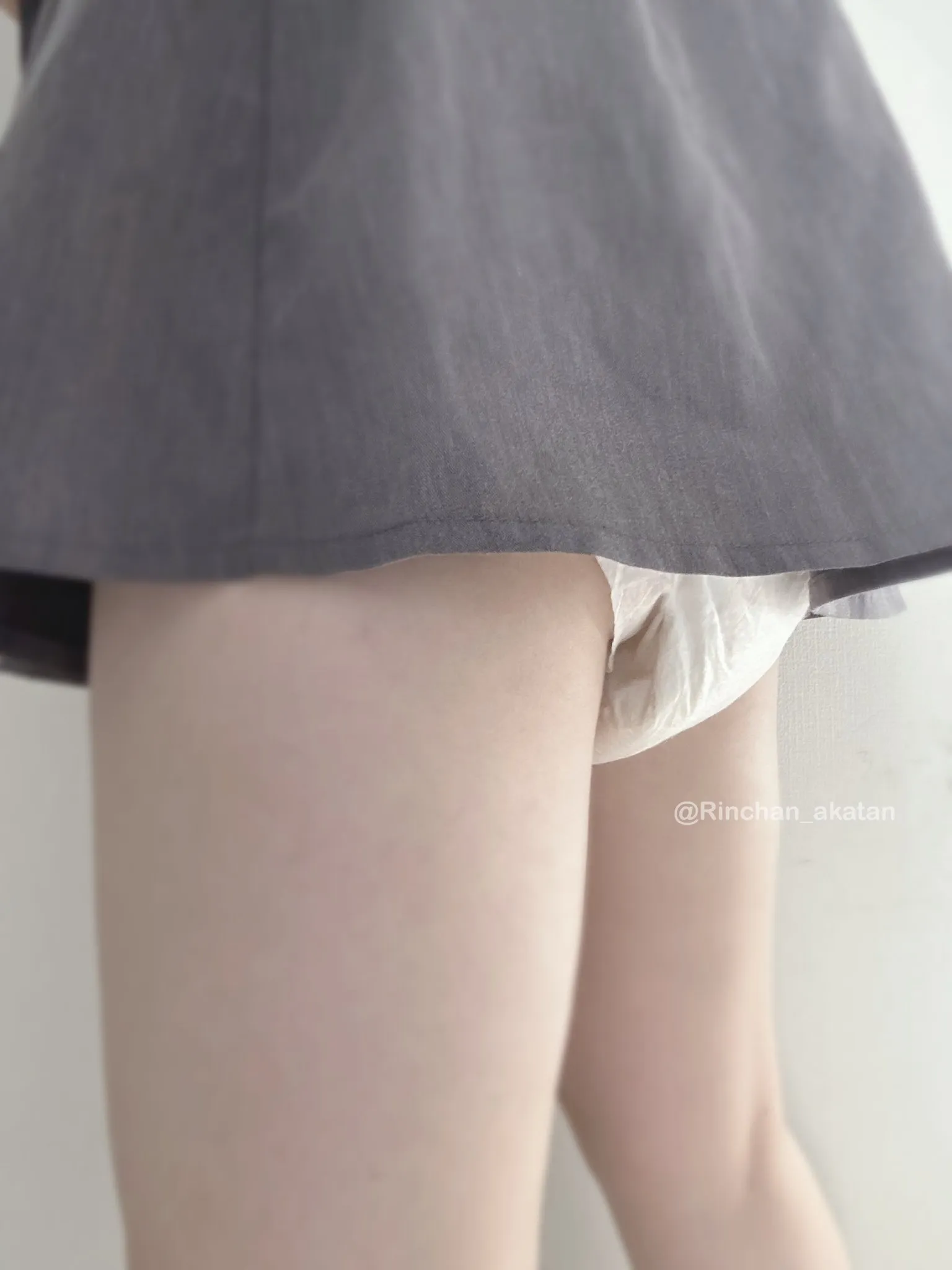 A white pull-up diaper is visible beneath the ABDL girl's skirt.