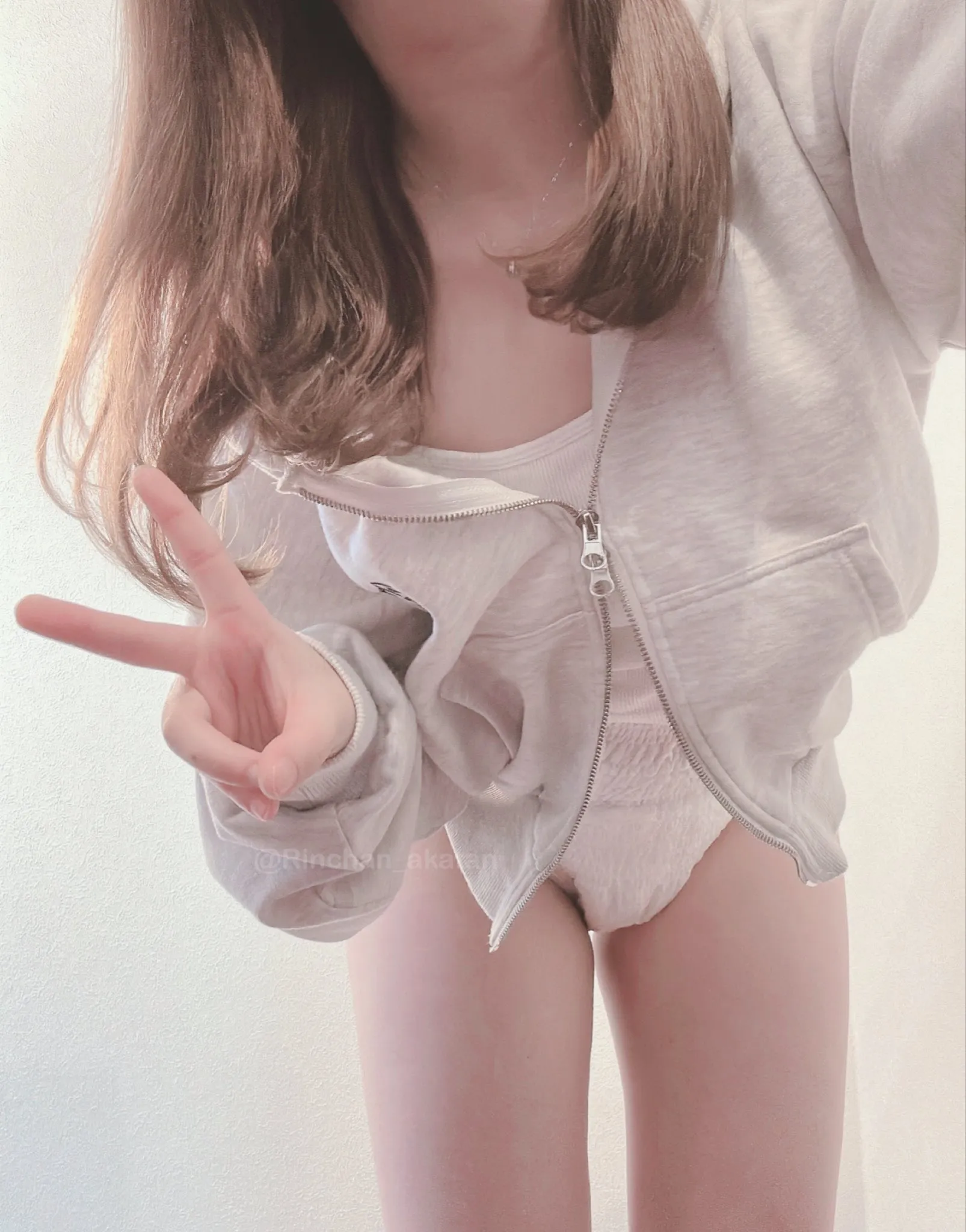 An ABDL girl is showing off her white pull-up diaper.