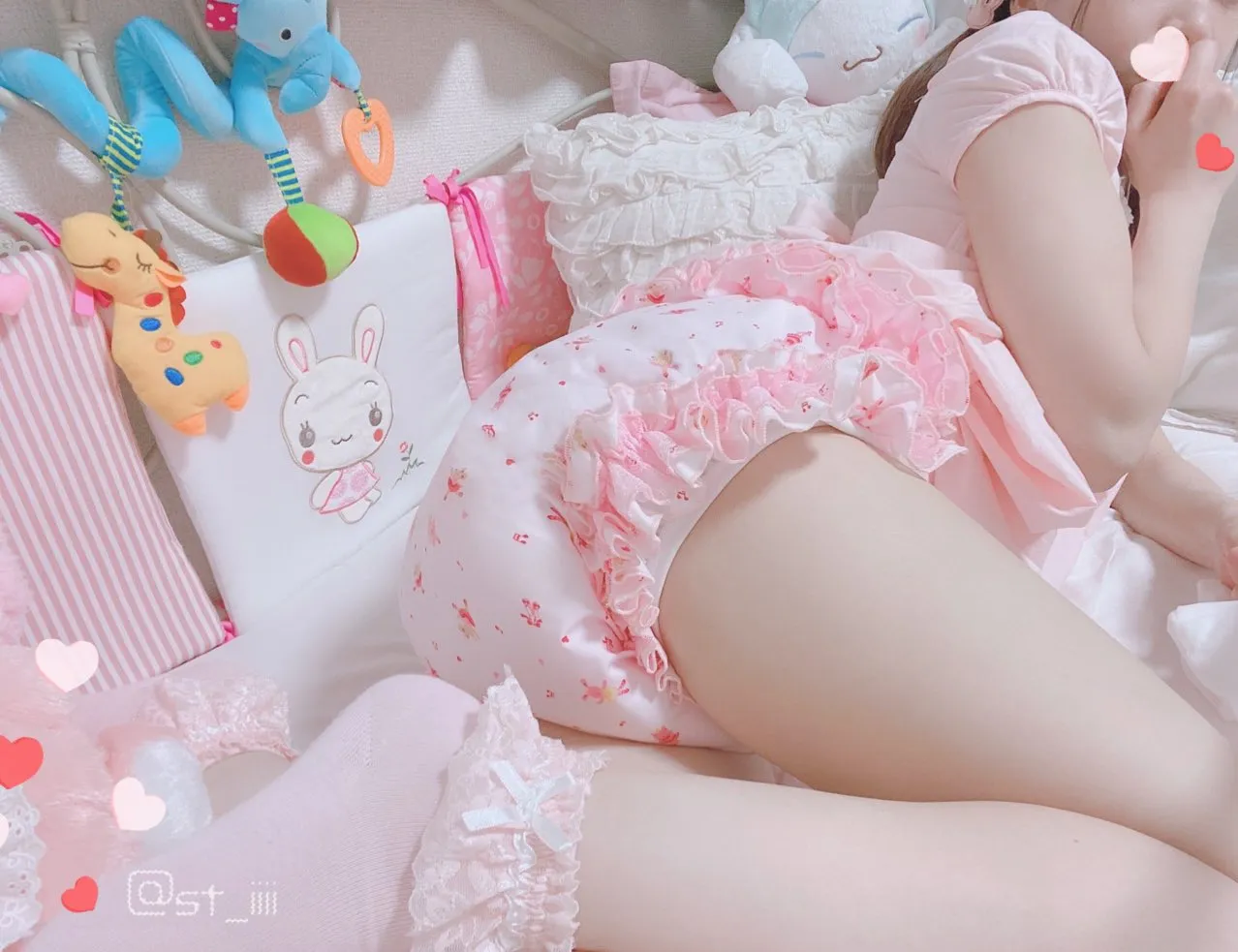 The ABDL girl is wearing infantile clothing and a diaper cover.