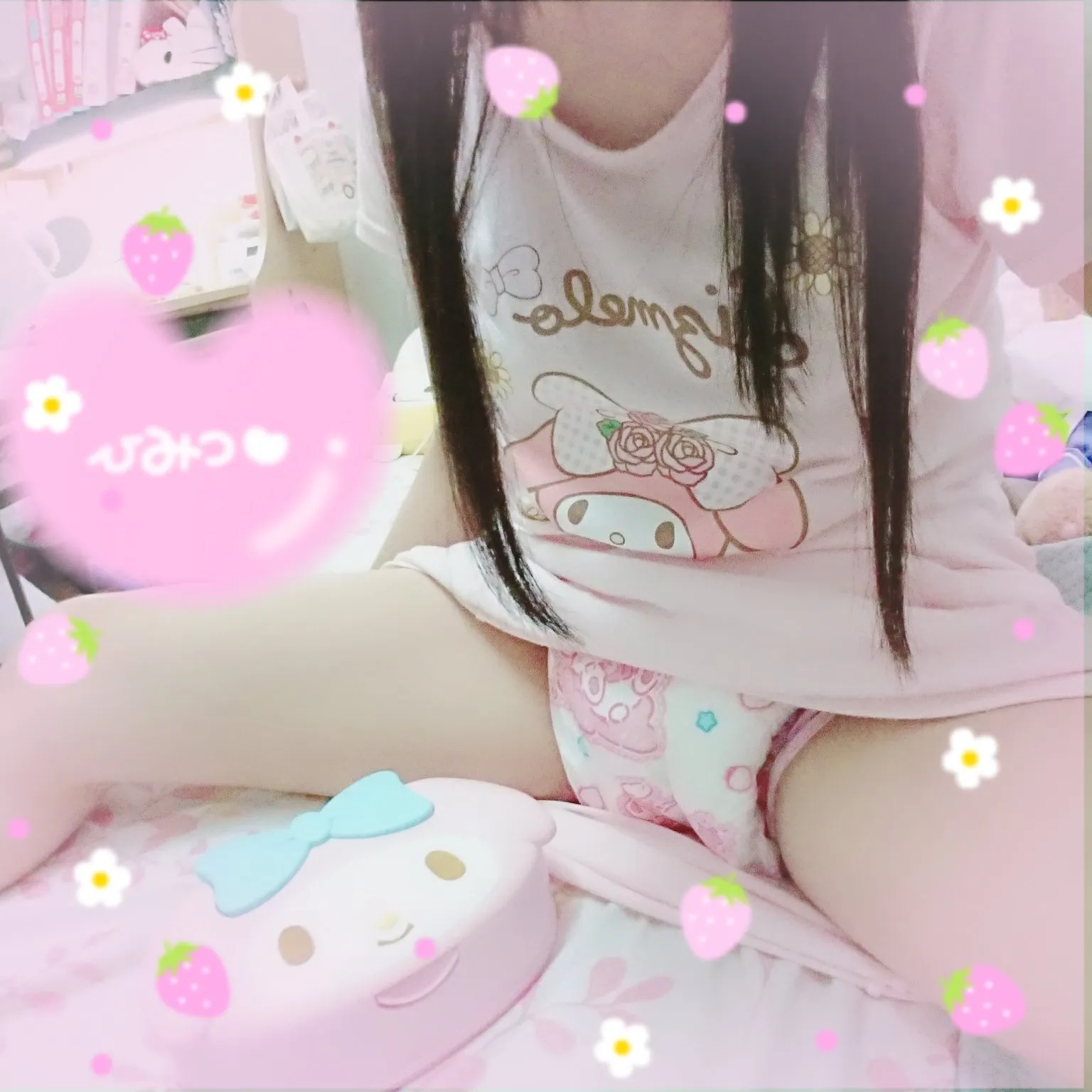 An ABDL girl sits on the bed, showing off her ABDL diaper through her skirt.