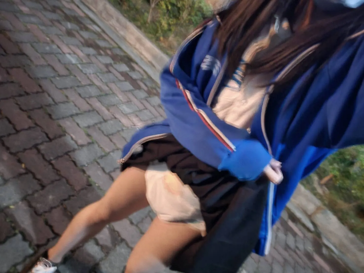 Lifting up the ABDL girl's skirt to reveal her ABDL diaper.