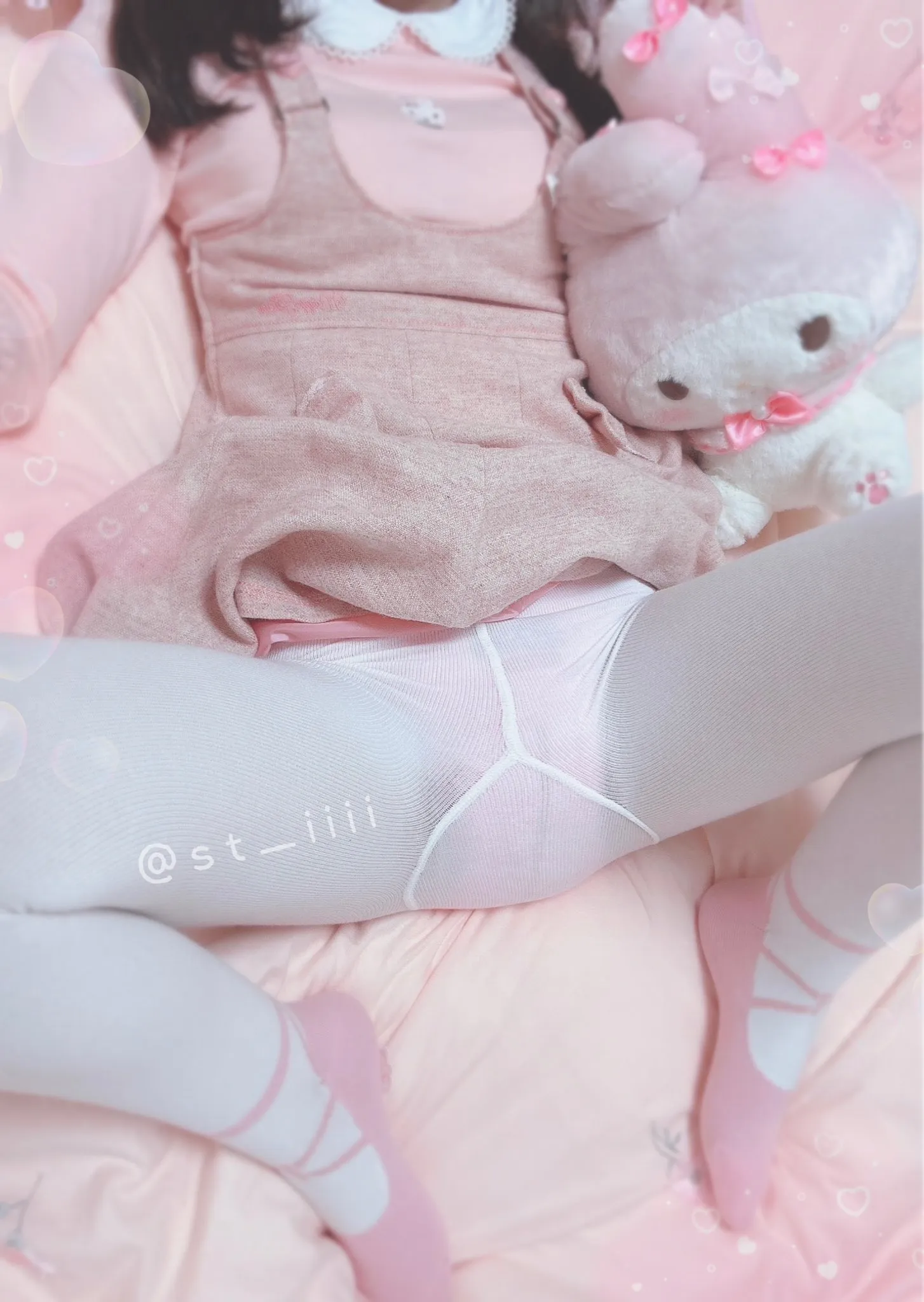The ABDL girl spreads her legs wide to show off her stockings and the diaper inside them.