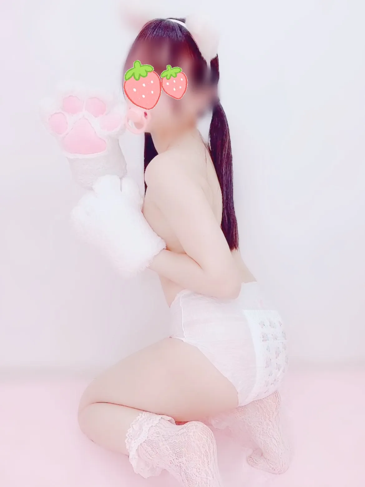 An ABDL girl sits holding a bubble wand, proudly showing off her diaper.