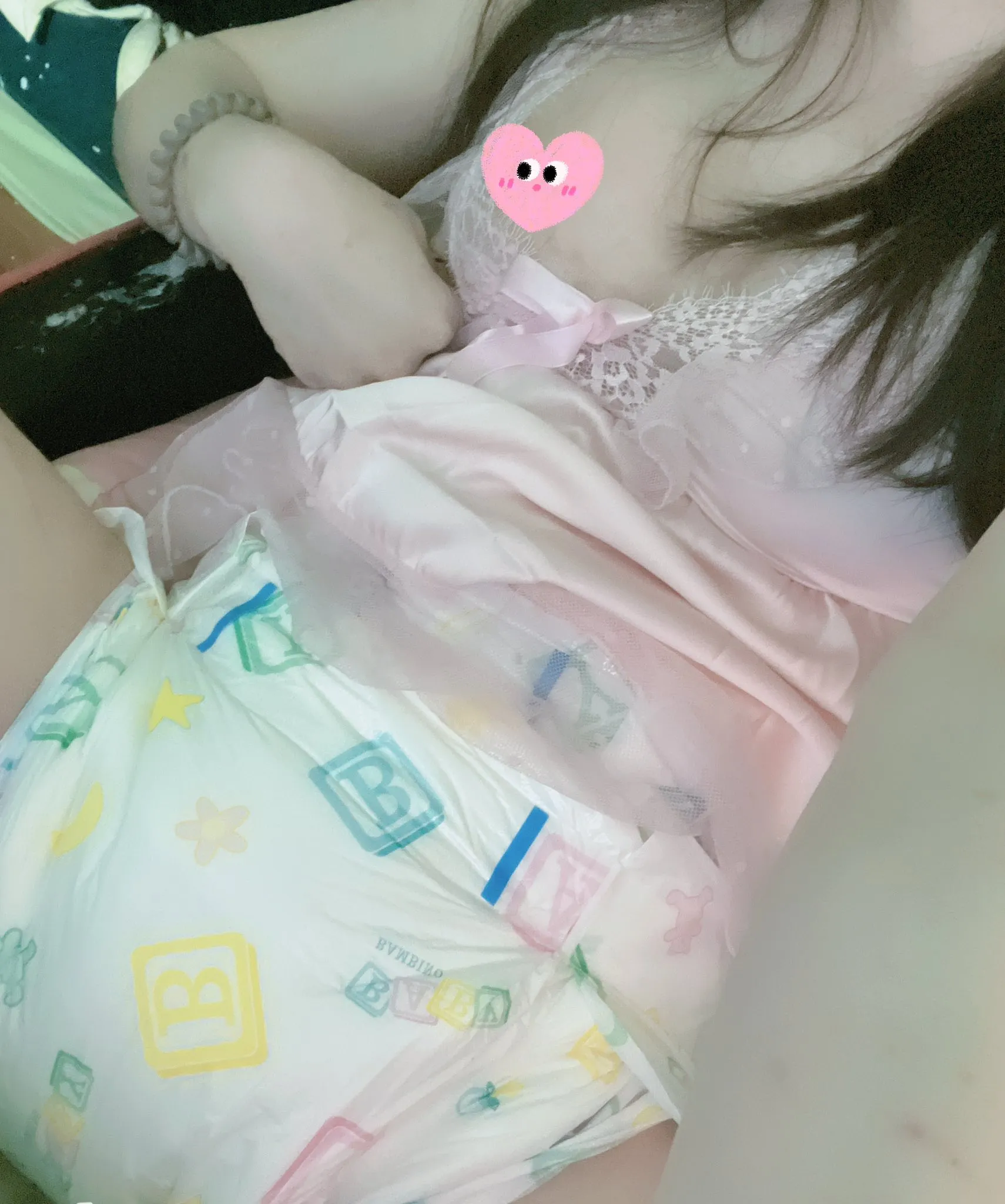 An ABDL girl wears a nightgown and shows off her ABDL diaper.