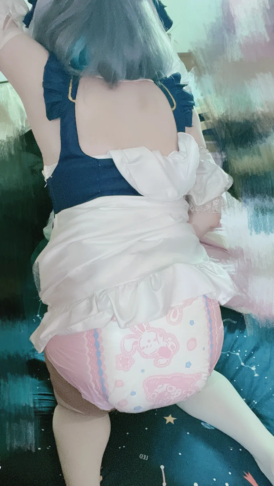 An ABDL girl is wearing a Bunny Hops ABDL diaper and is in a doggy style position.