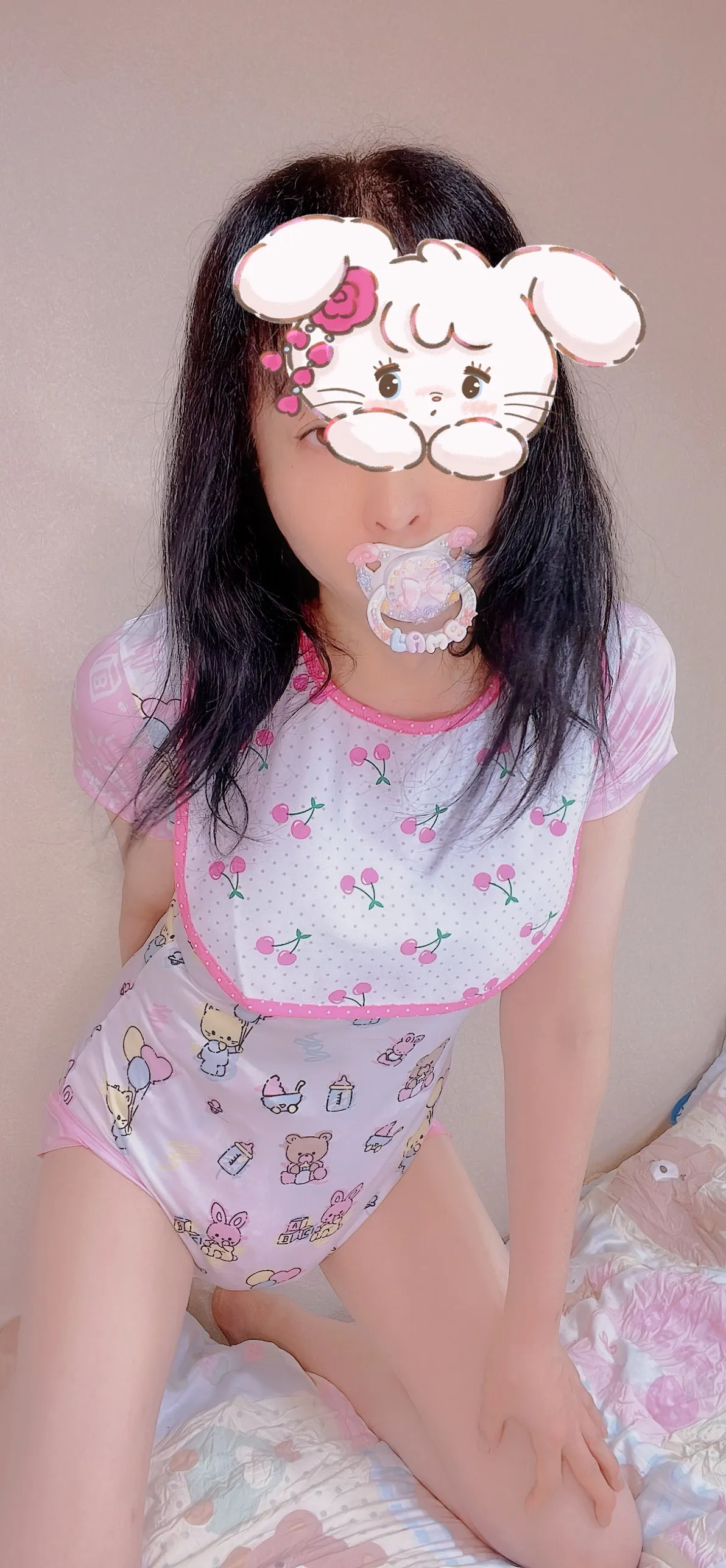 An ABDL girl wearing a bib and romper