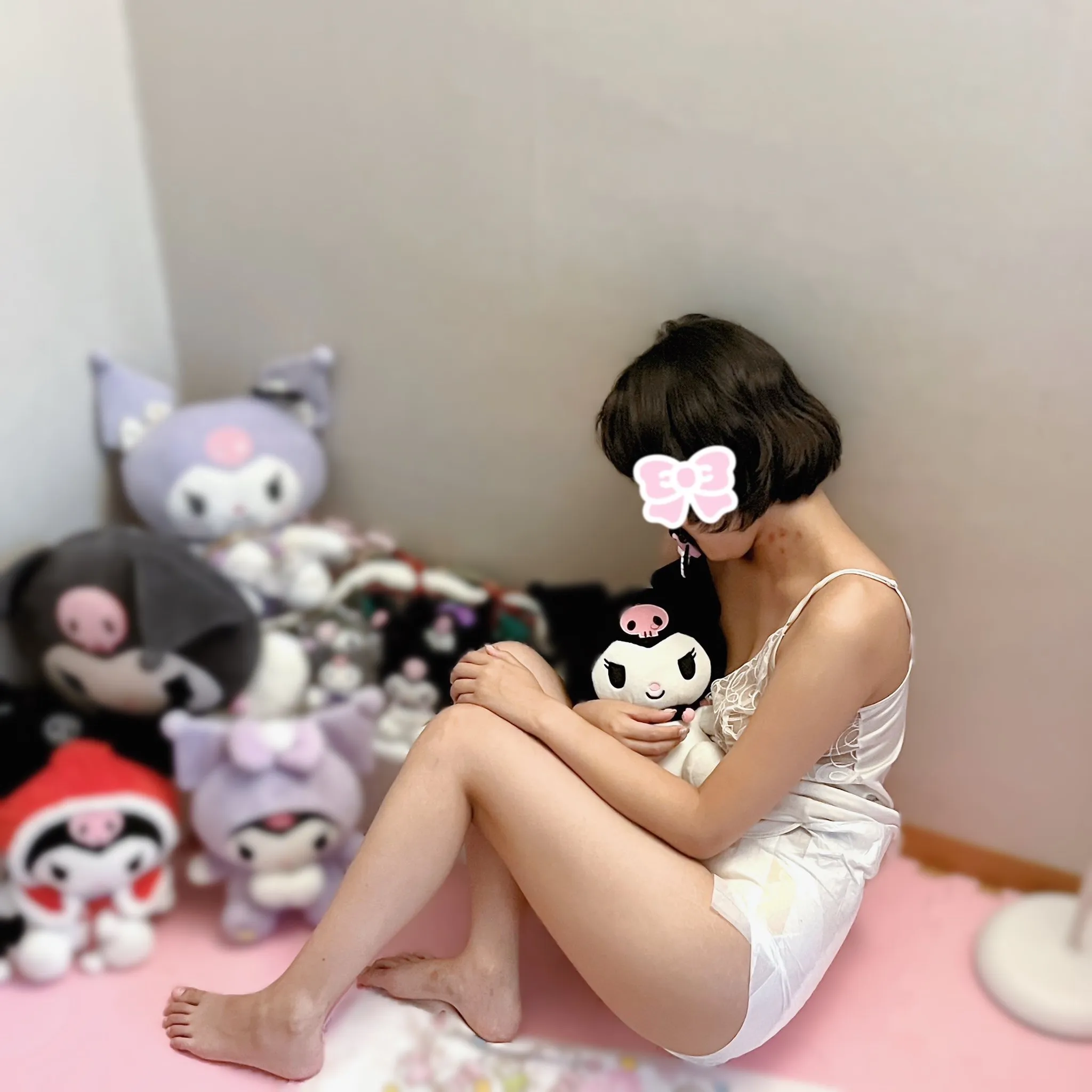 An ABDL girl wearing a tank top and holding a Kuromi doll