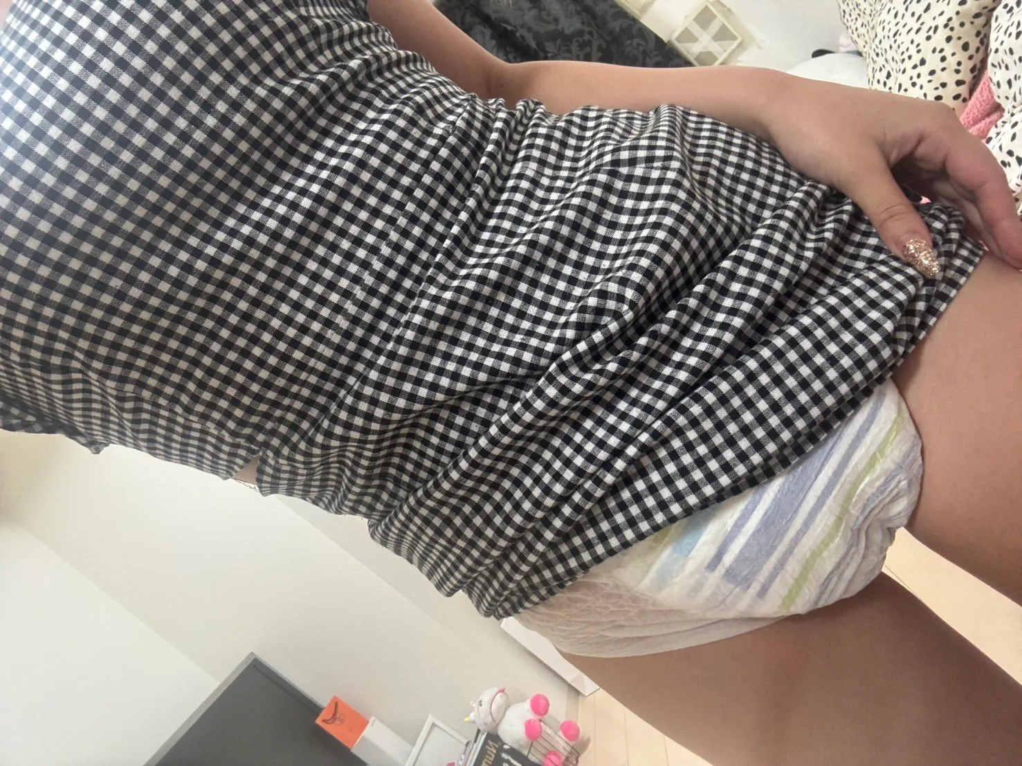 A diaper visible beneath a tight dress ABDL girl