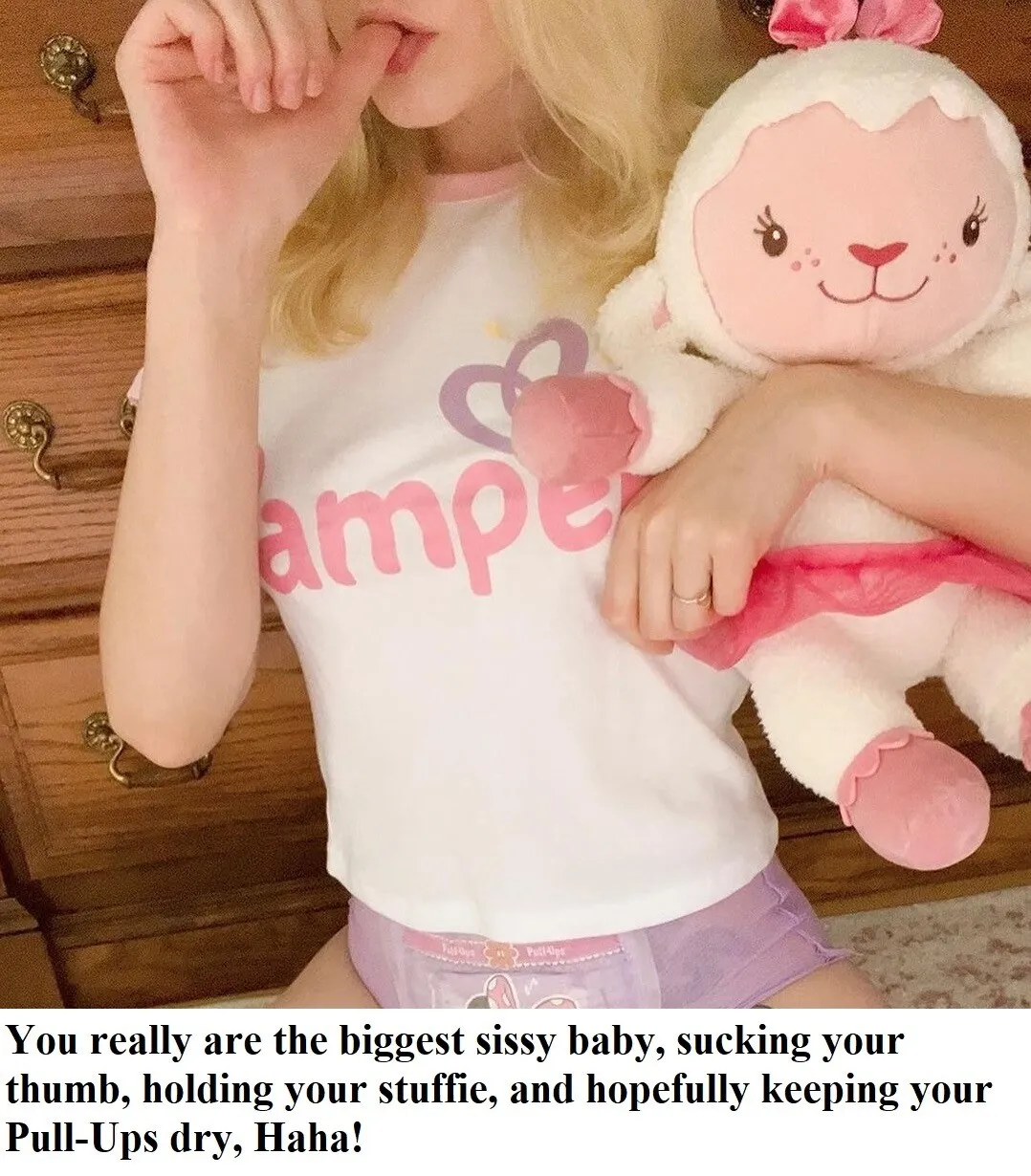An ABDL girl sucks her thumb while wearing a diaper and holding a doll.