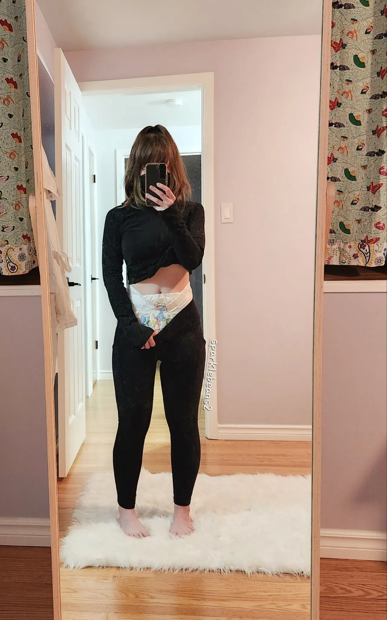 As the ABDL girl pulled down her pants, a white diaper was exposed.