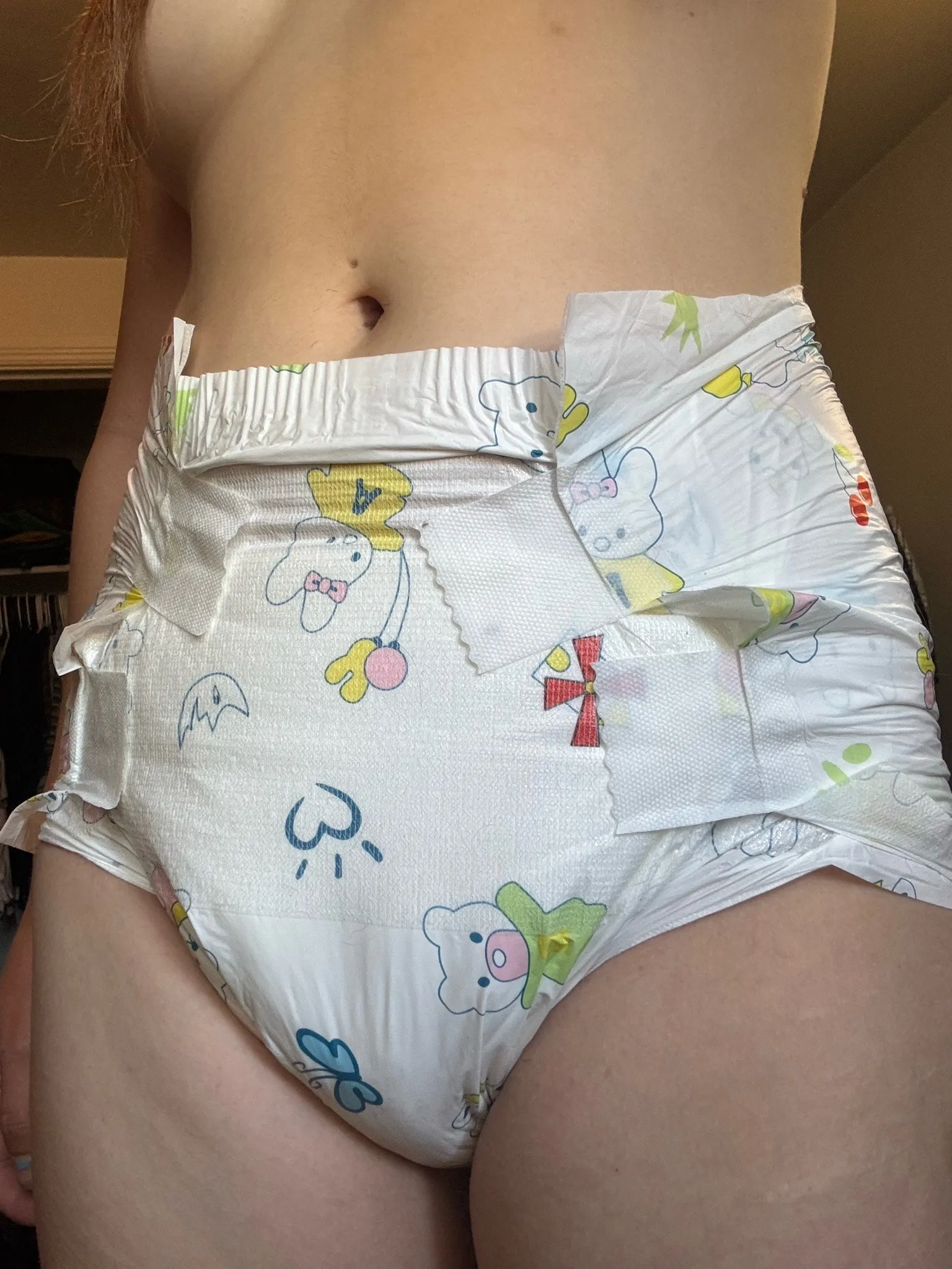 An ABDL girl shows off her underbust and white diaper.