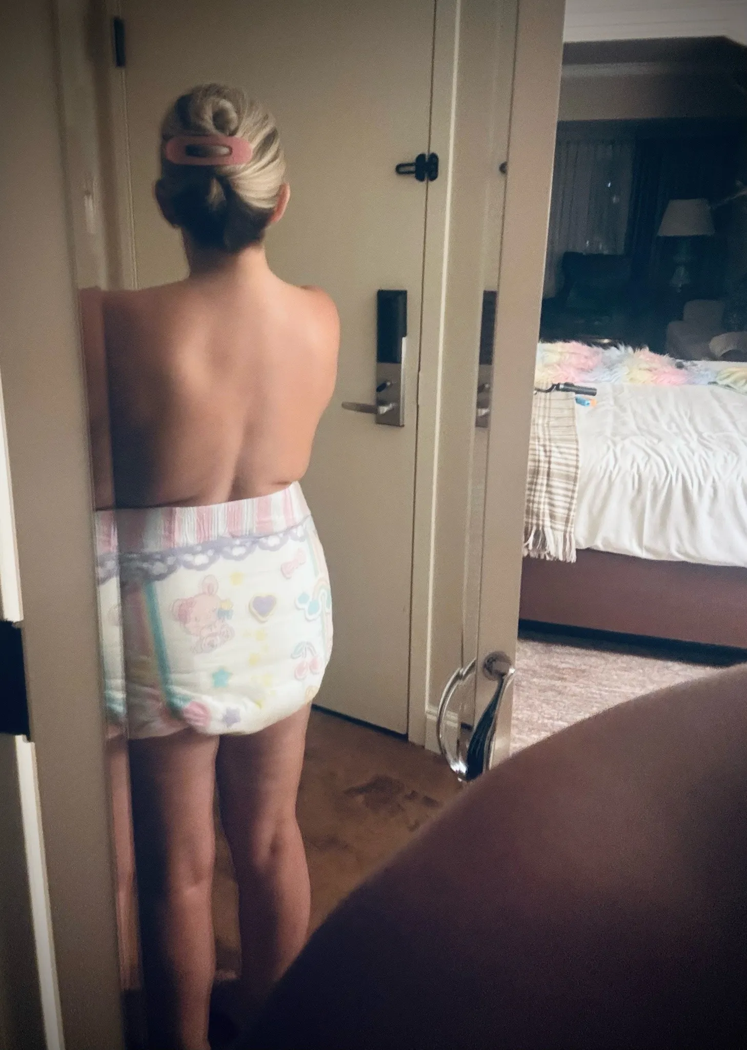 An ABDL girl shows off her diapered backside.