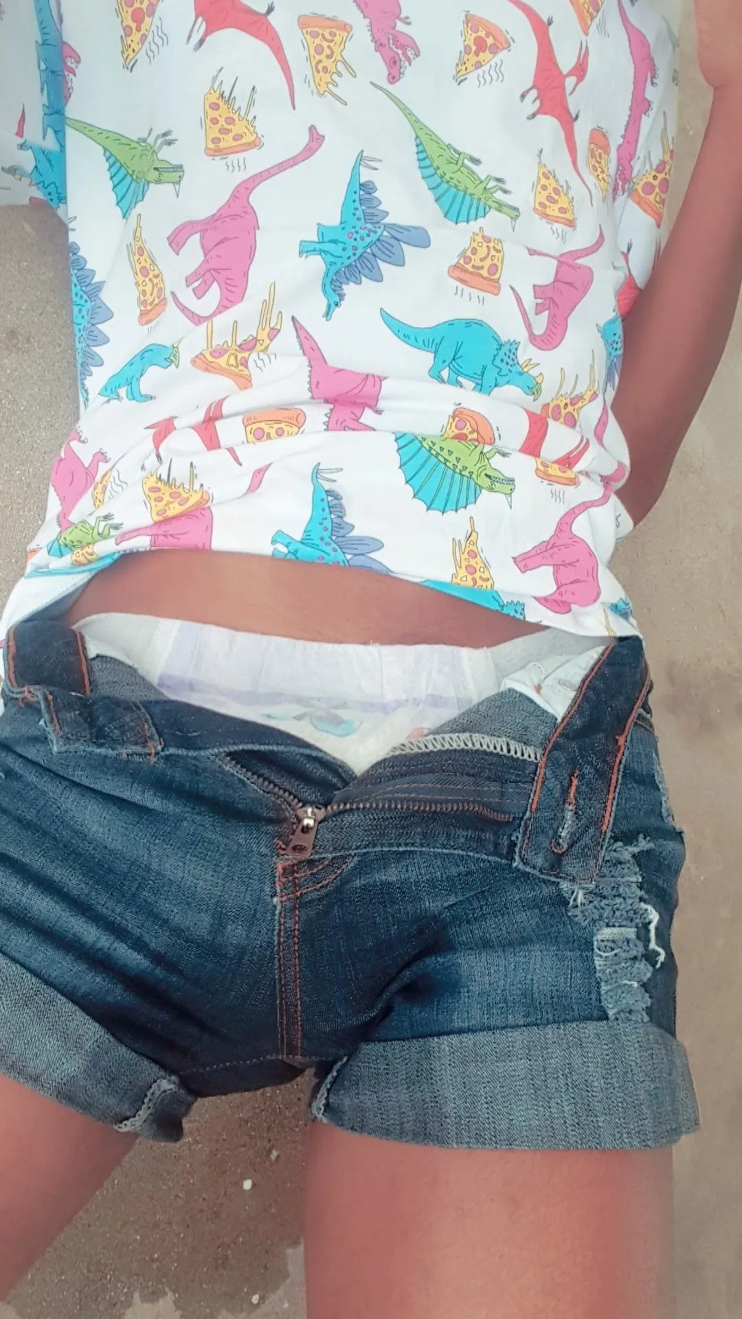 The ABDL girl is wearing a diaper under her short denim shorts, and pee has overflowed and soaked everything.