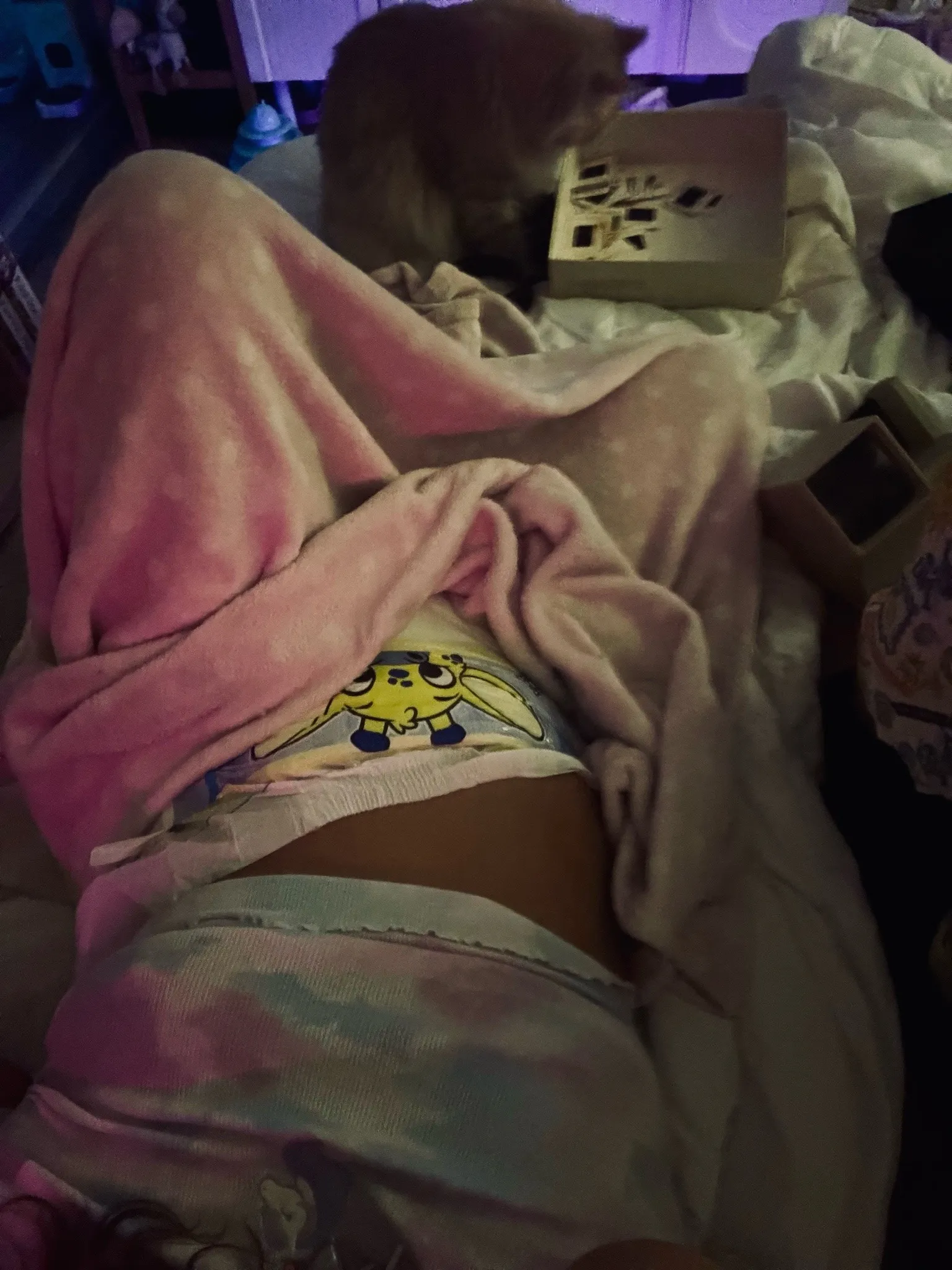 An ABDL girl lies down and shows off her Peekabu diaper.