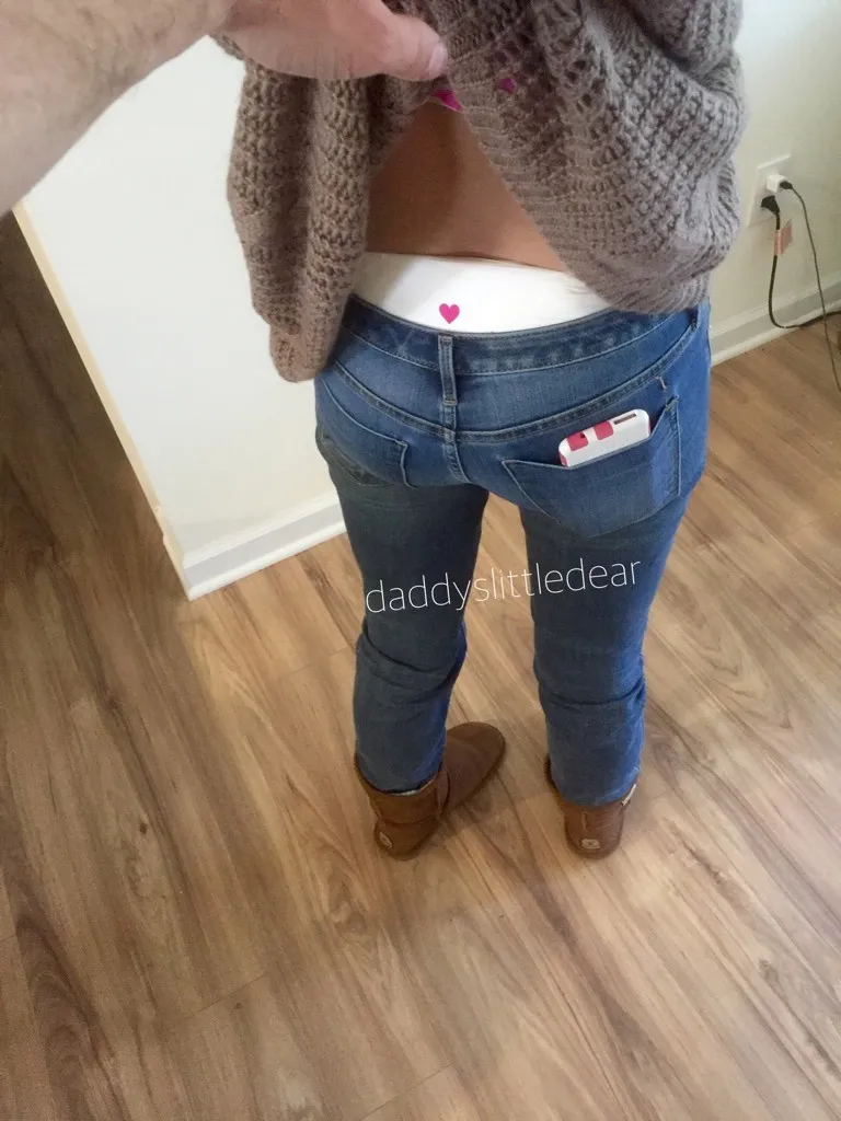 The waistband of the diaper is visible over the ABDL girl's jeans.