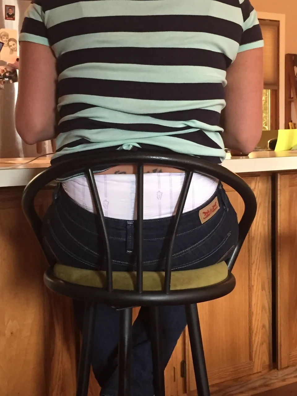 The waistband of the diaper is visible over the ABDL girl's jeans.