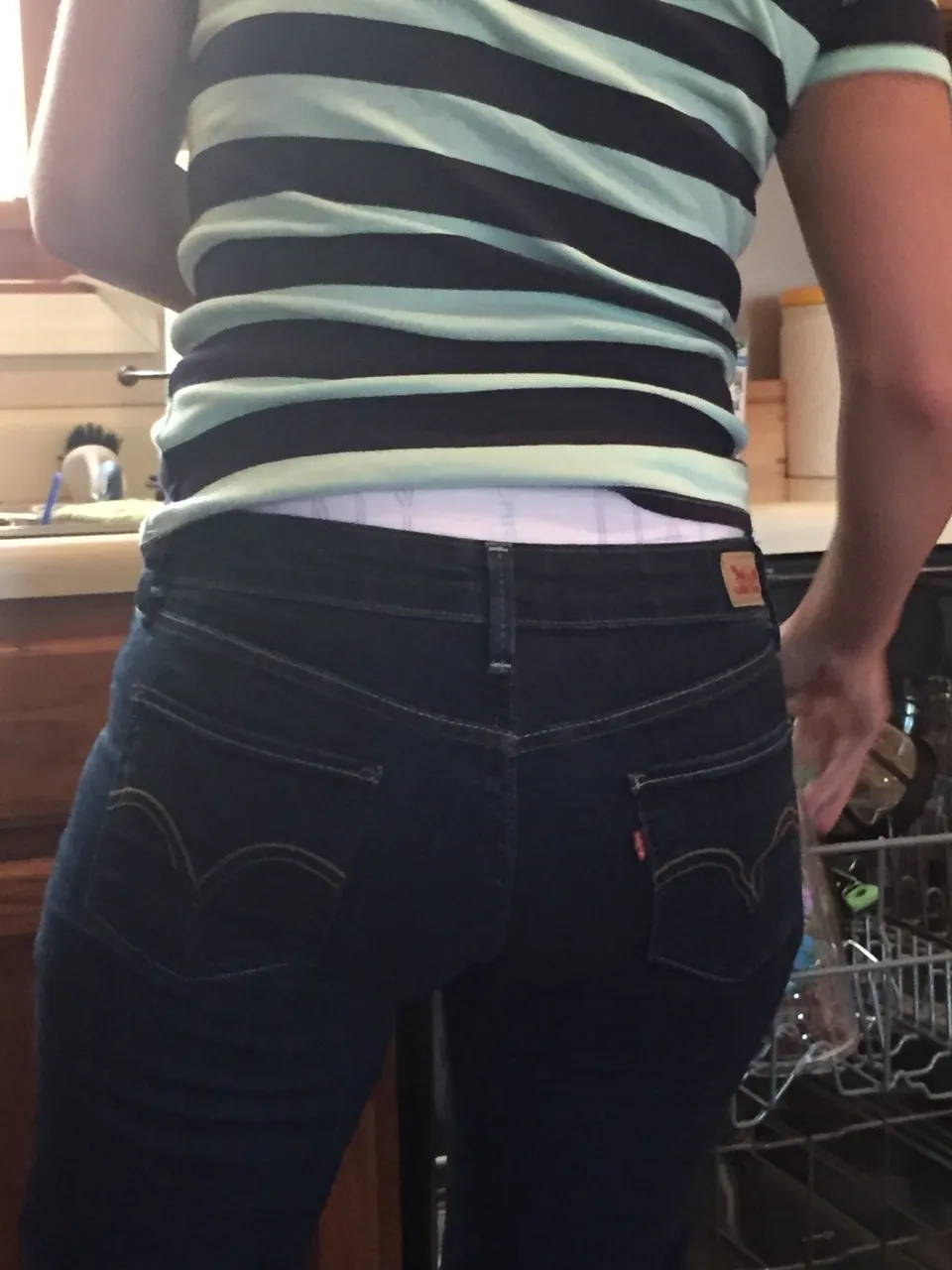 The waistband of the diaper is visible over the ABDL girl's jeans.