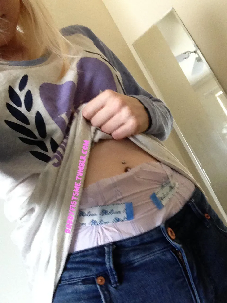 The waistband of the diaper is visible over the ABDL girl's jeans.