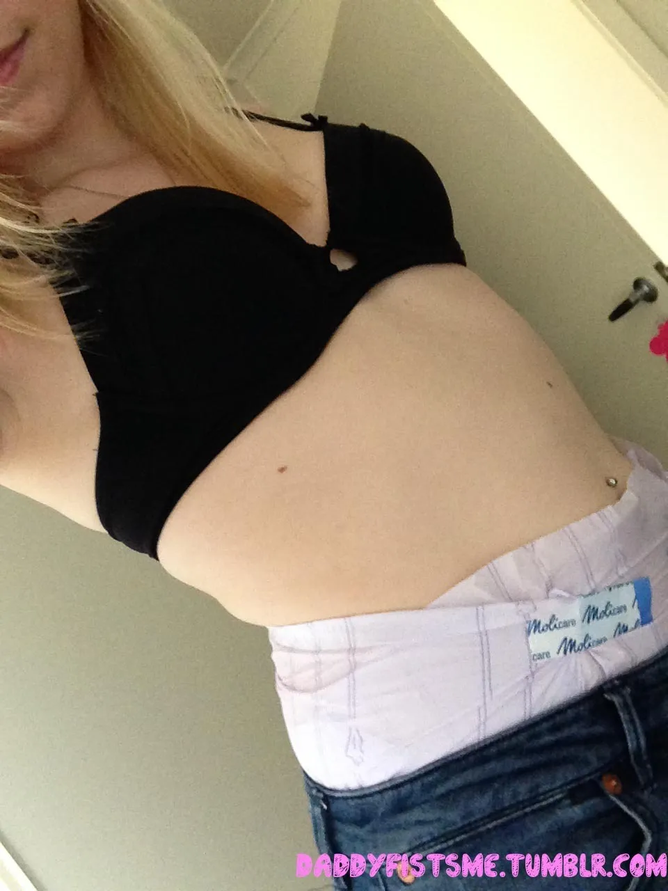 The waistband of the diaper is visible over the ABDL girl's jeans.