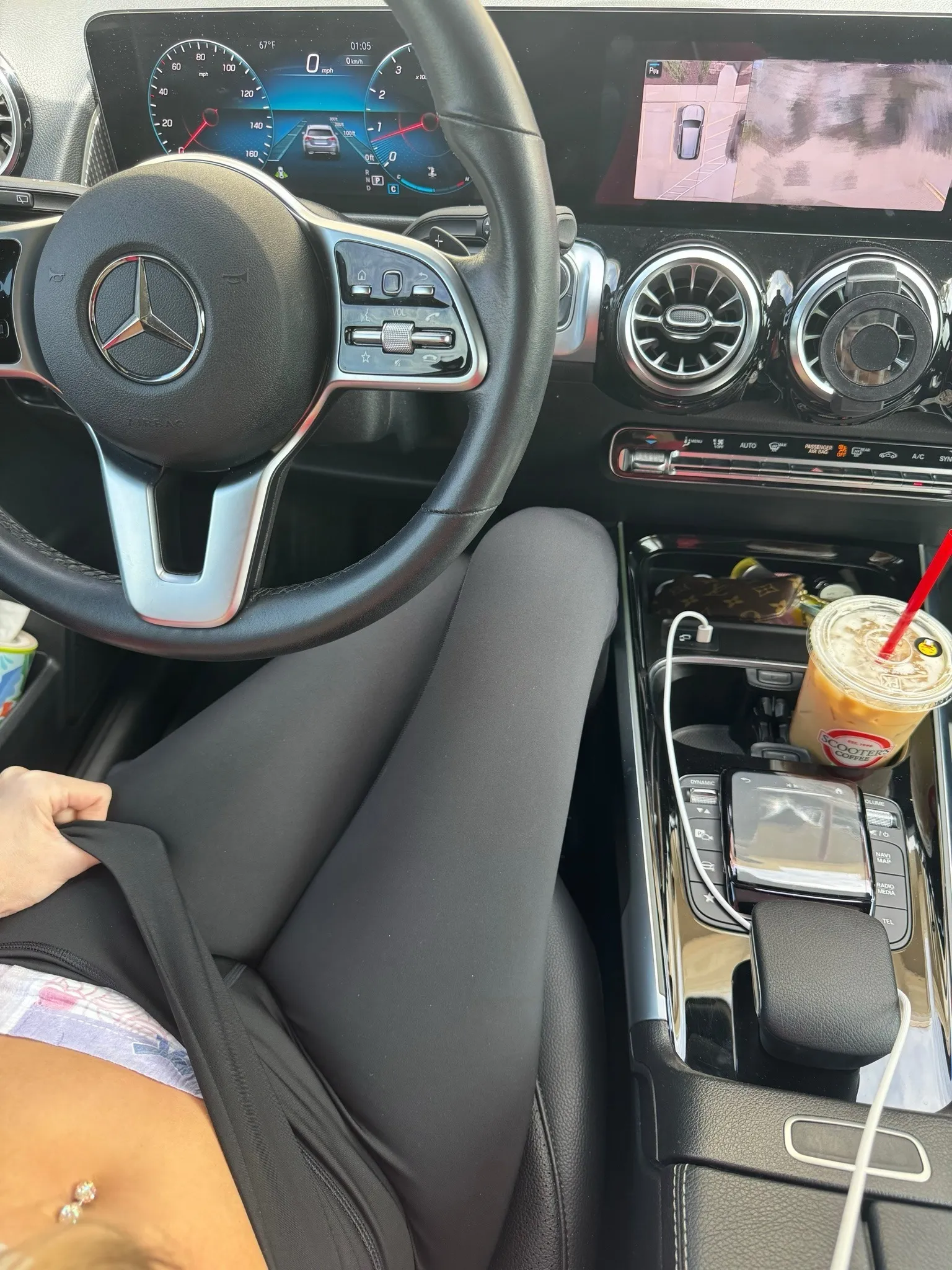 An ABDL girl pulls down her leggings in the driver's seat of a Benz to show off her diaper.