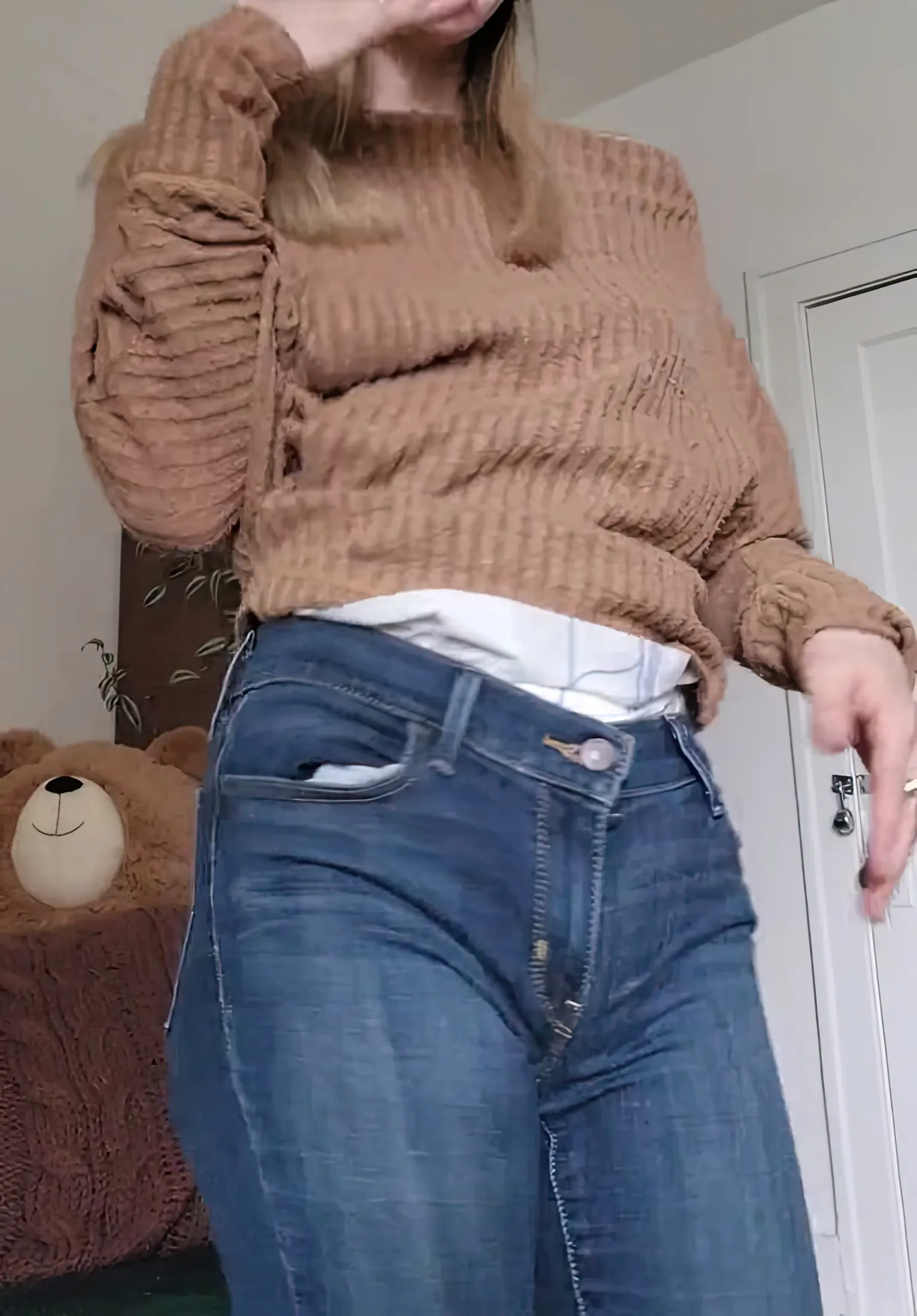 The waistband of the diaper is visible over the ABDL girl's jeans.