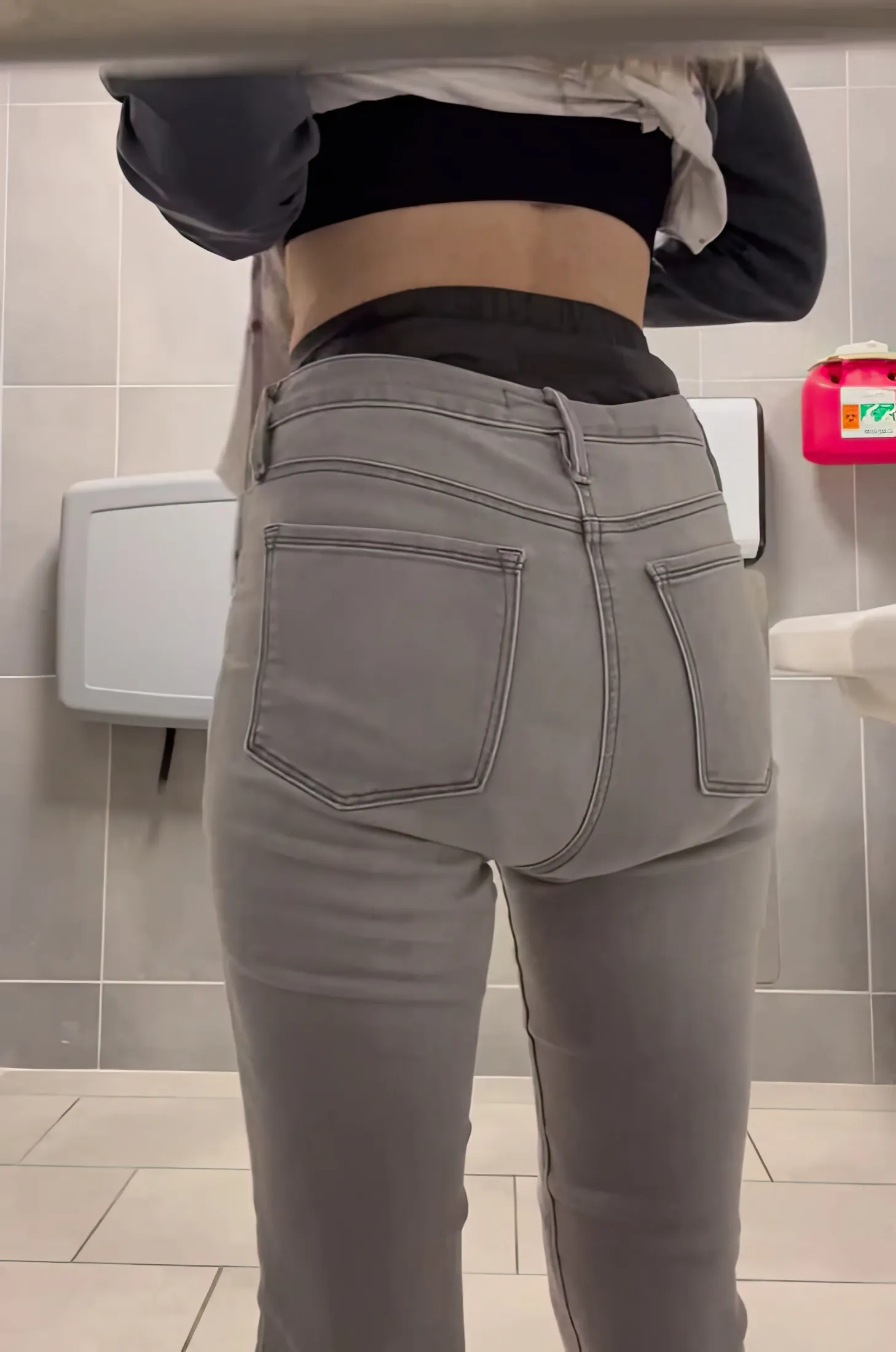 ABDL girl exposes waistband of MegaMax diaper in public restroom.