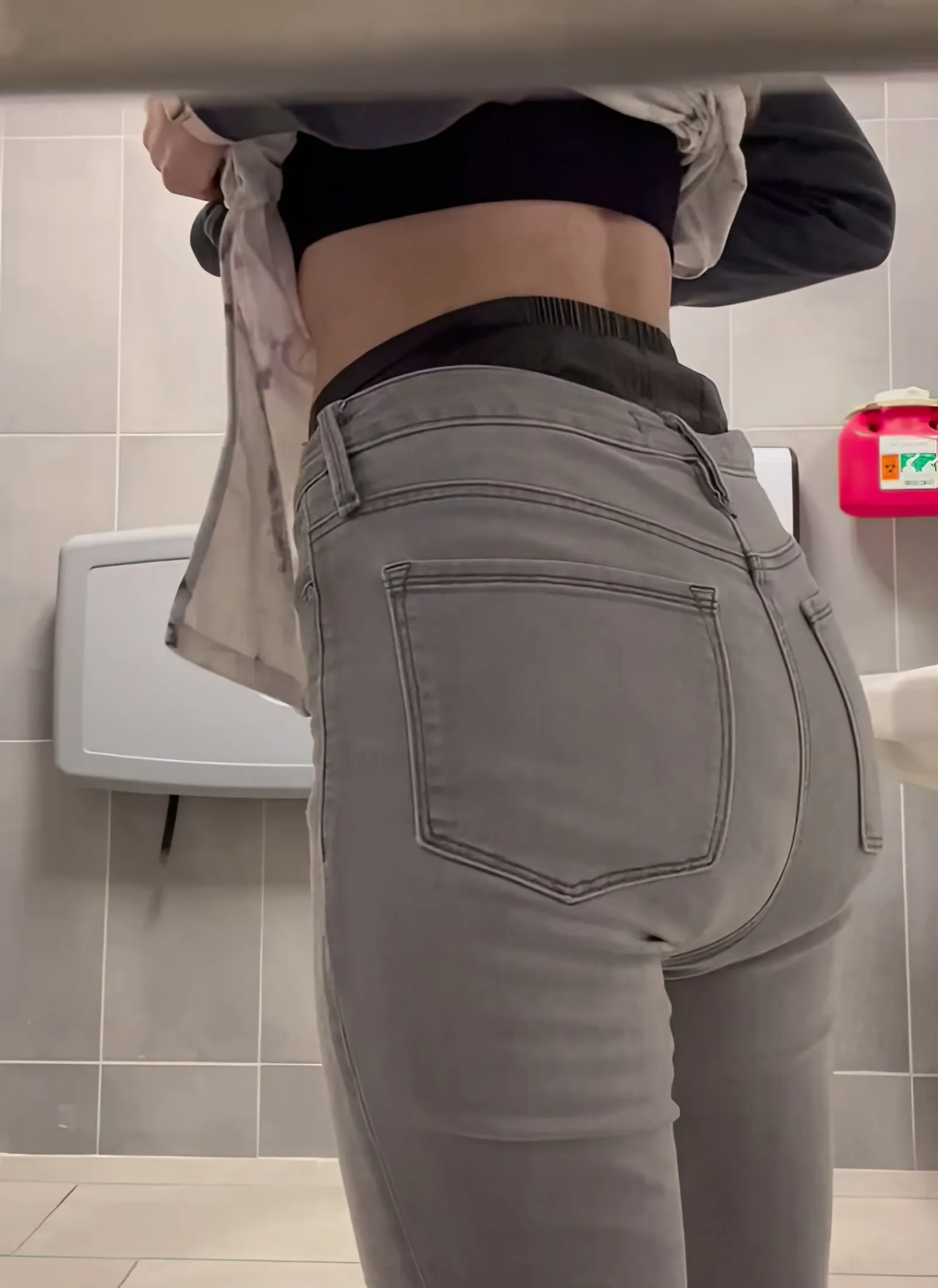 ABDL girl exposes waistband of MegaMax diaper in public restroom.