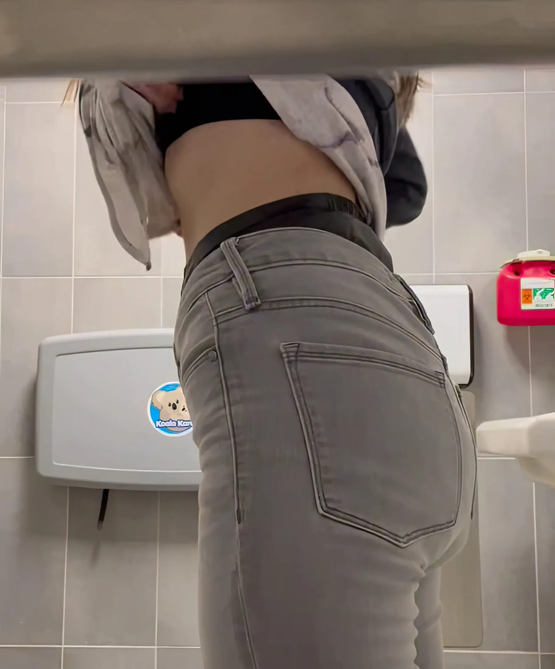 ABDL girl exposes waistband of MegaMax diaper in public restroom.
