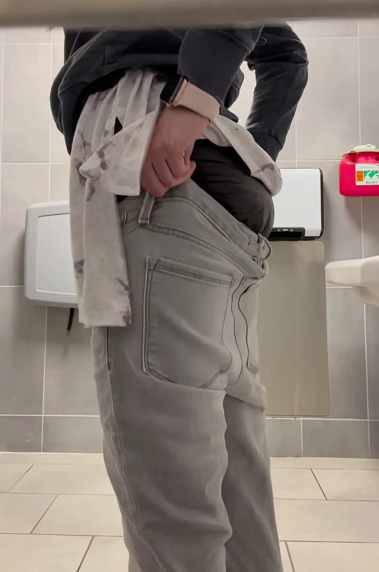 ABDL girl exposes waistband of MegaMax diaper in public restroom.