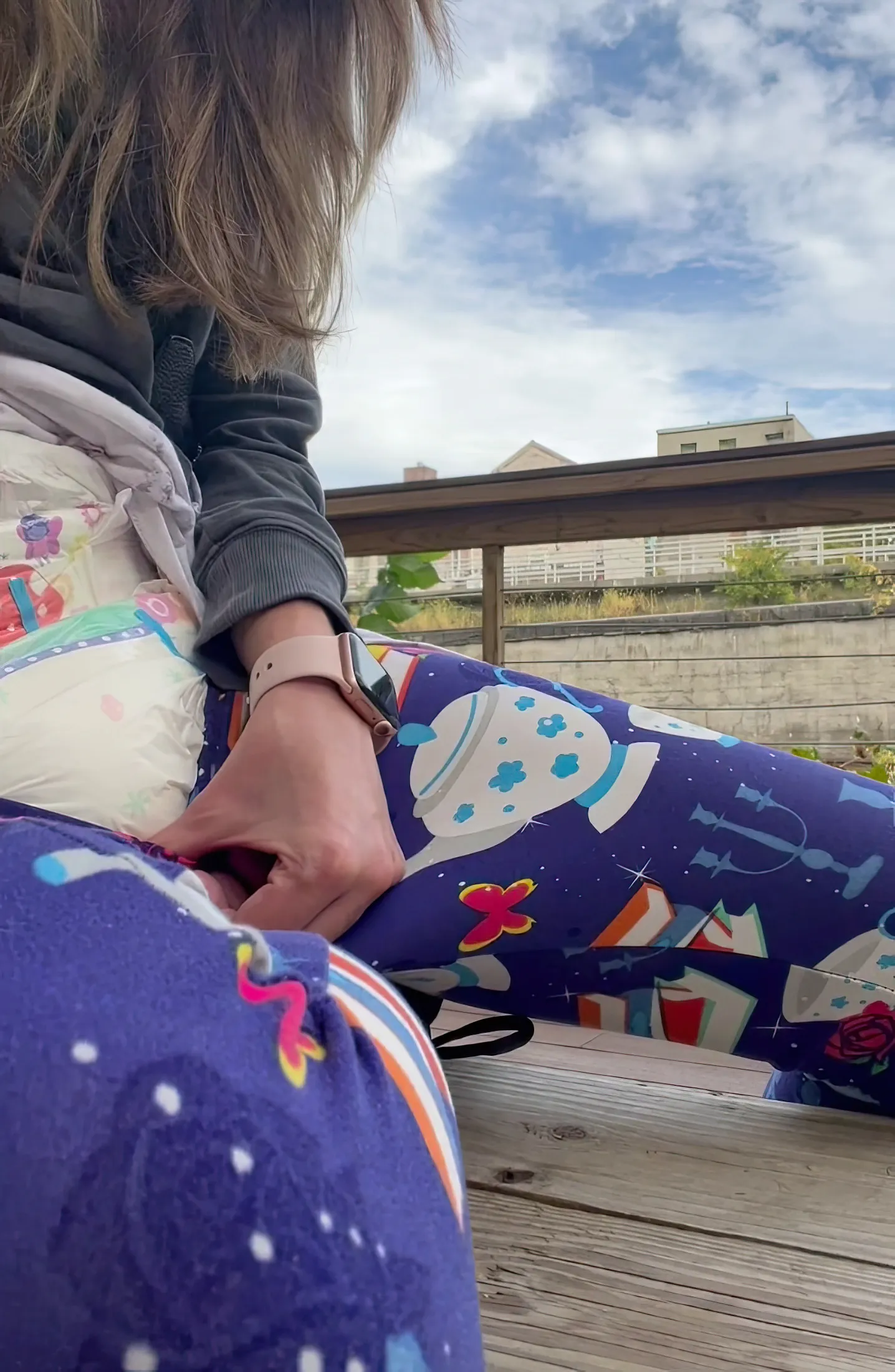 ABDL girl pulls down her leggings outdoors to show off her diaper.