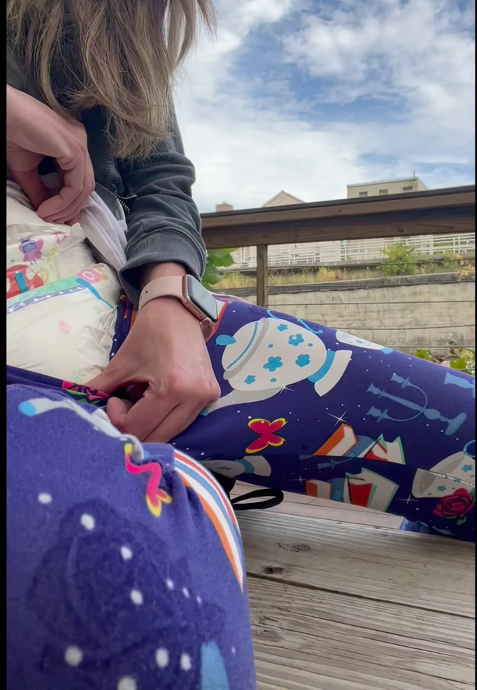 ABDL girl pulls down her leggings outdoors to show off her diaper.