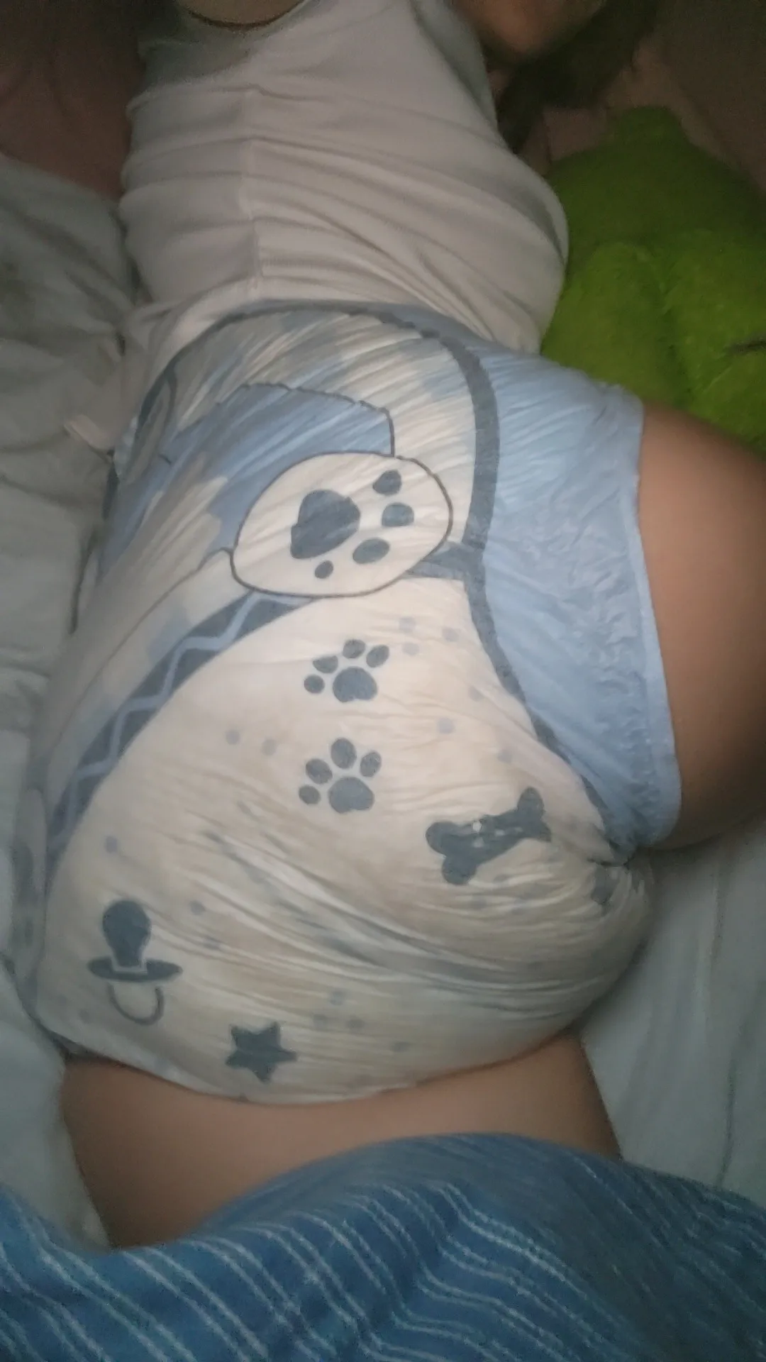 ABDL girl showing off her wet LittleForBig diaper in bed.