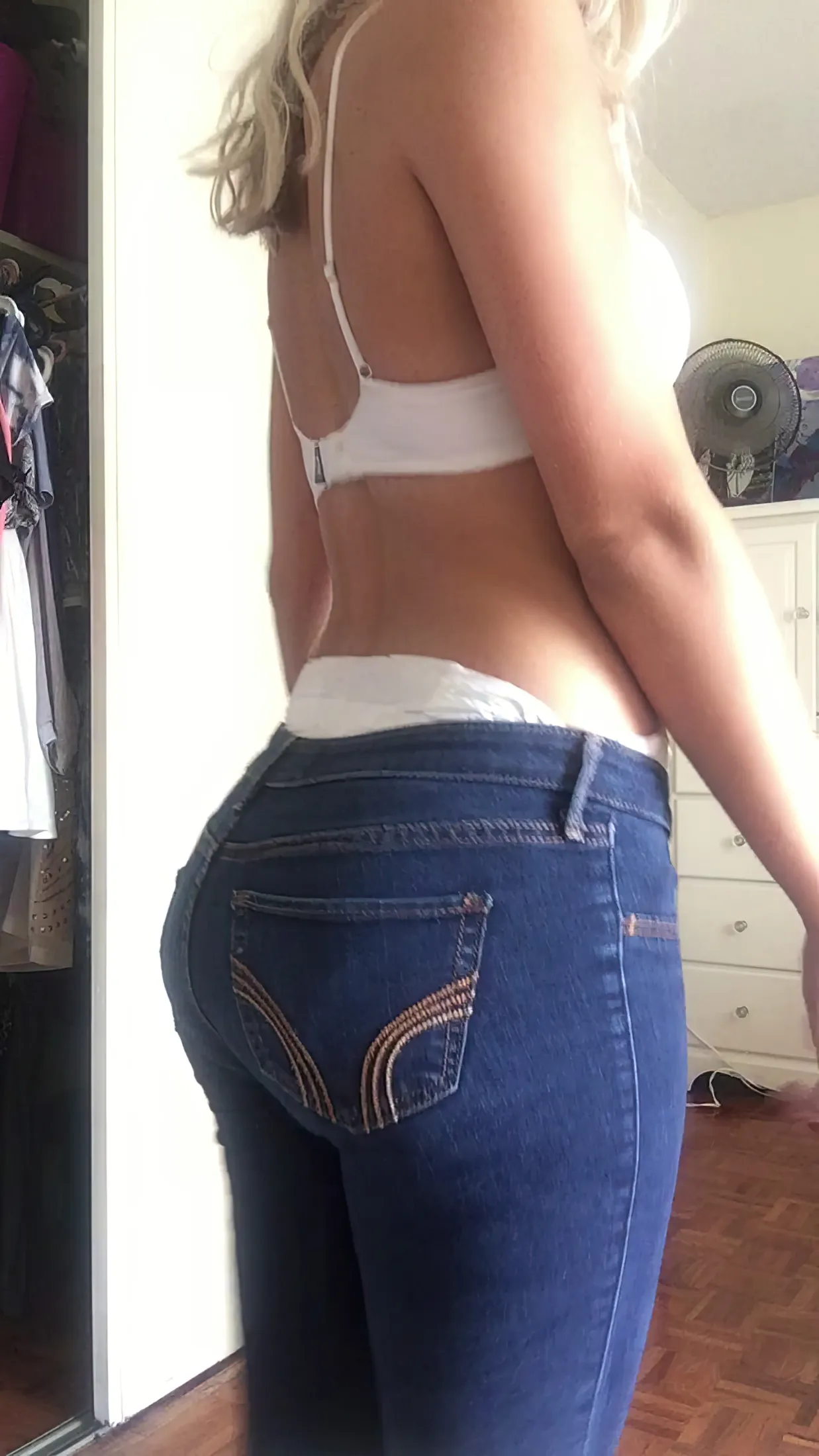 The waistband of the diaper is visible above the ABDL girl's jeans.