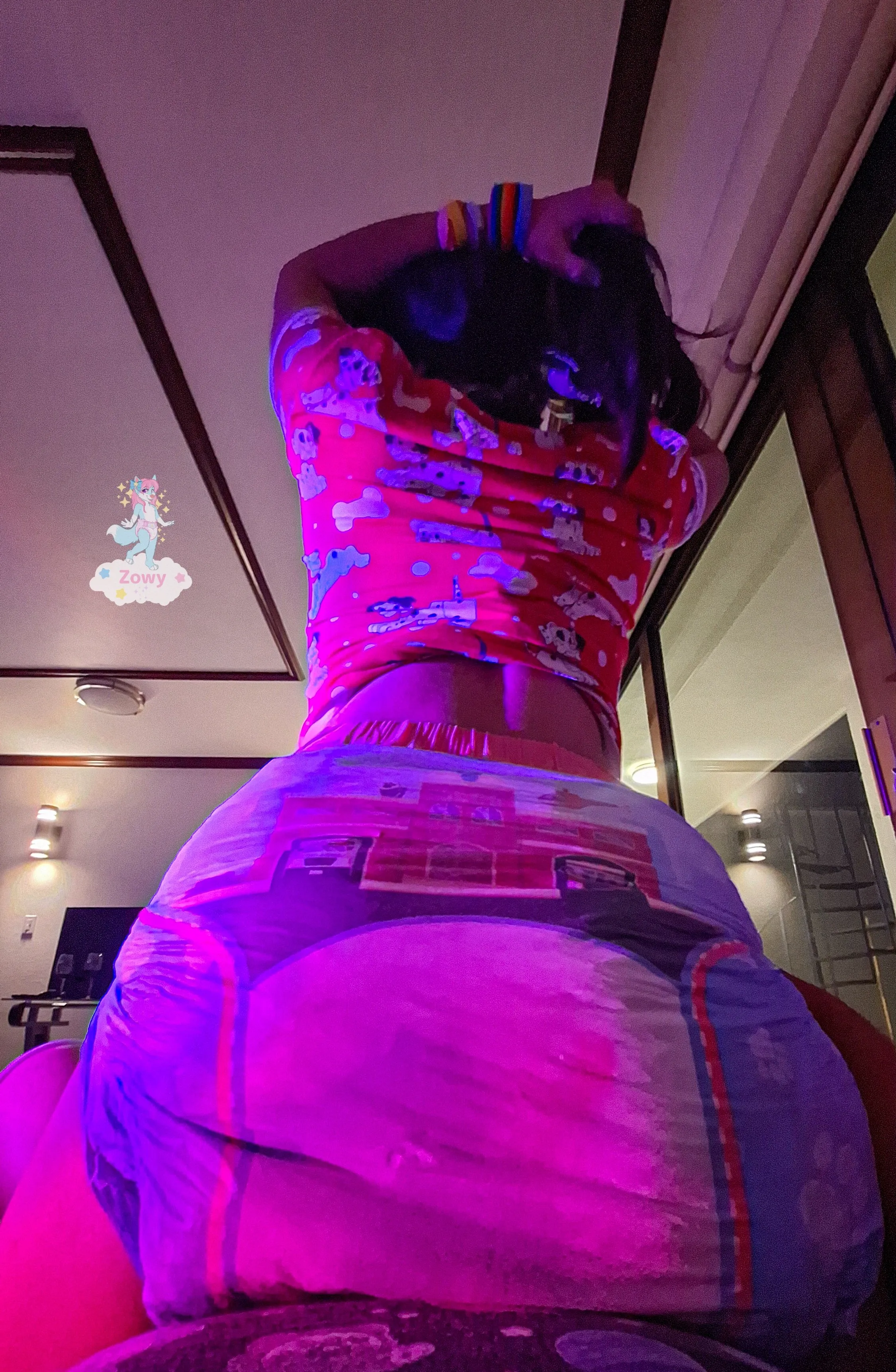 An ABDL girl sits on a man's cock while wearing a diaper soaked in urine.