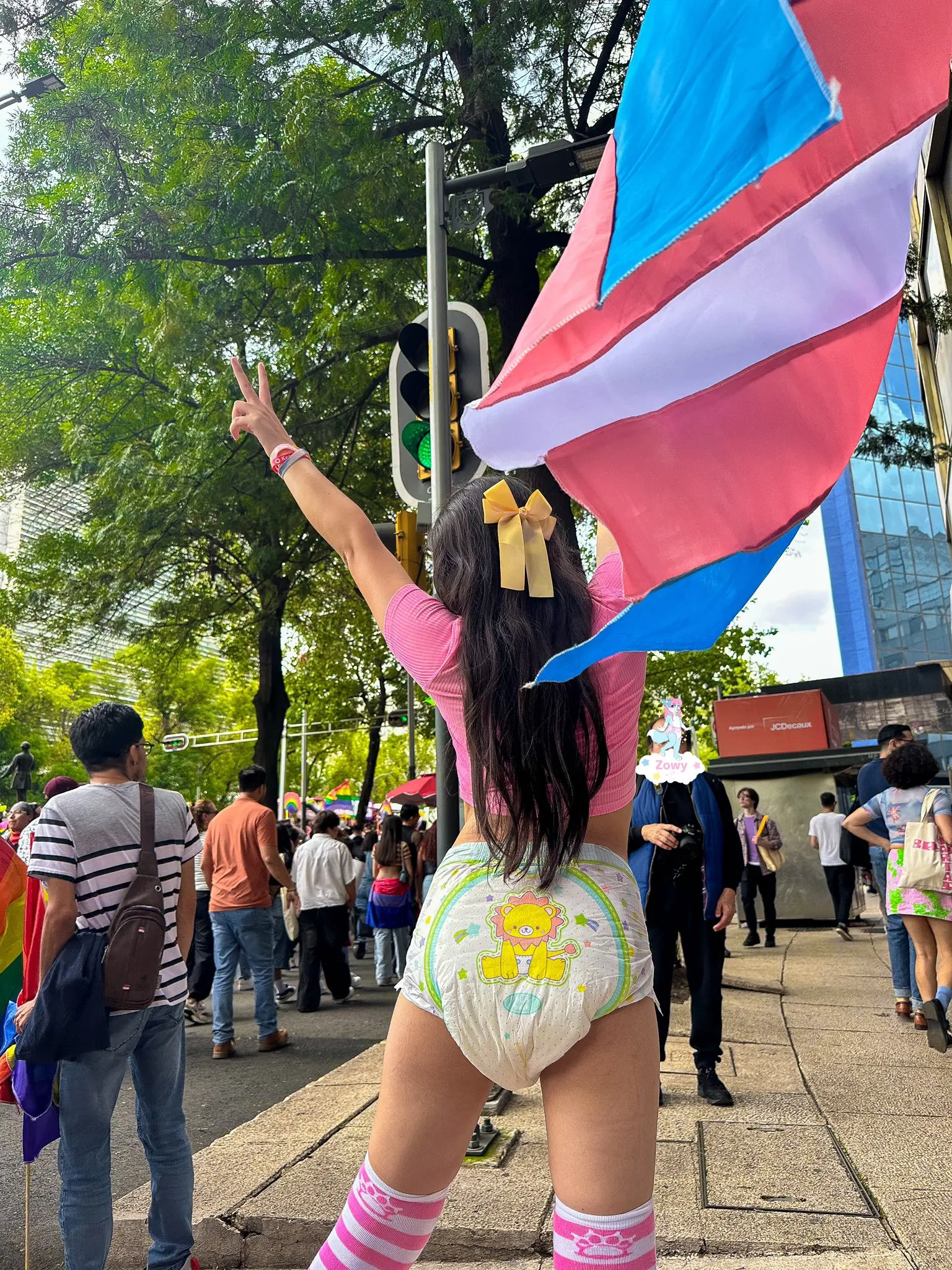 An ABDL girl poses on the street wearing only a TryAgain diaper underneath.