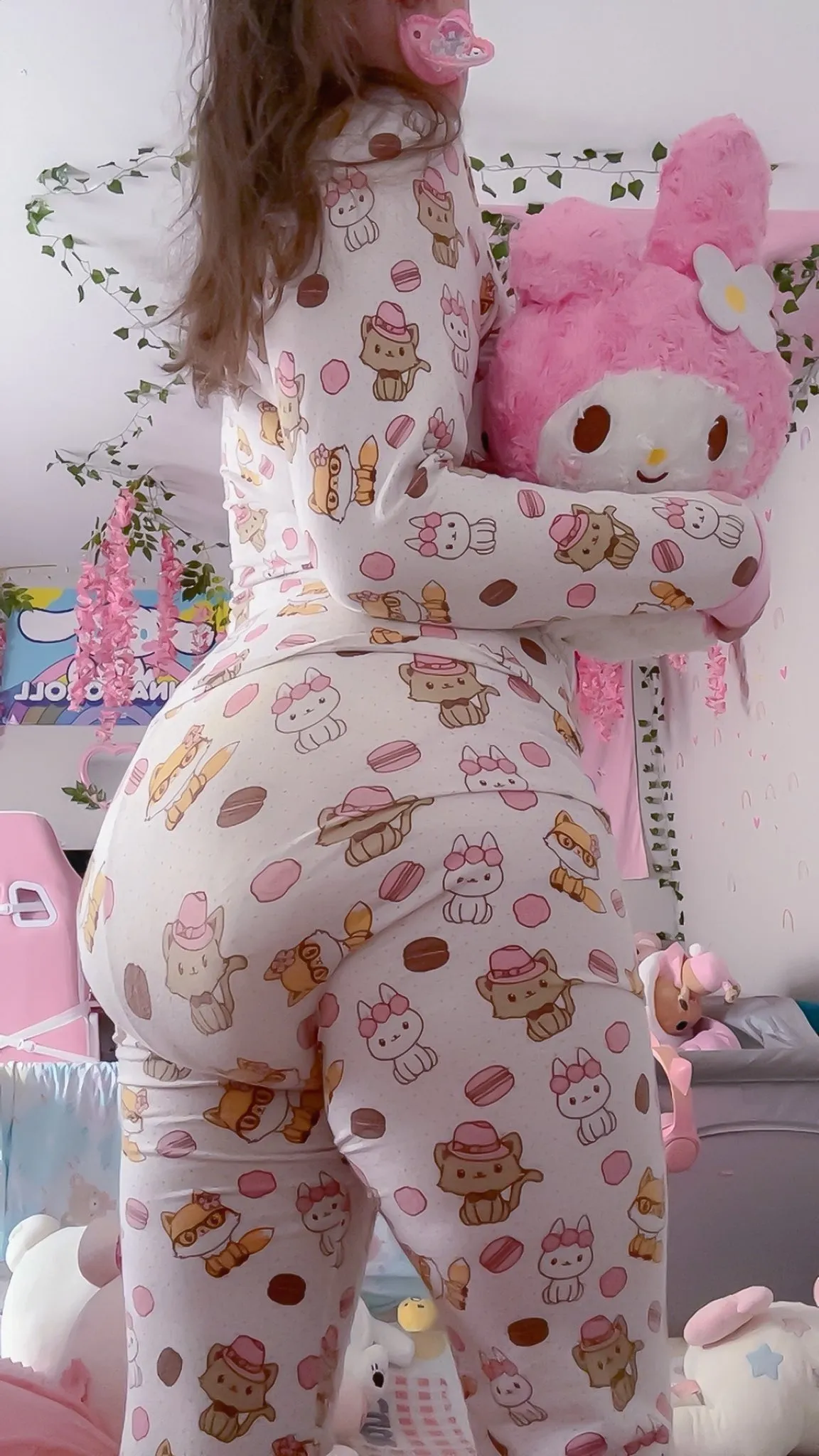 ABDL girl flaunts the silhouette of a giant diaper beneath her pajamas.