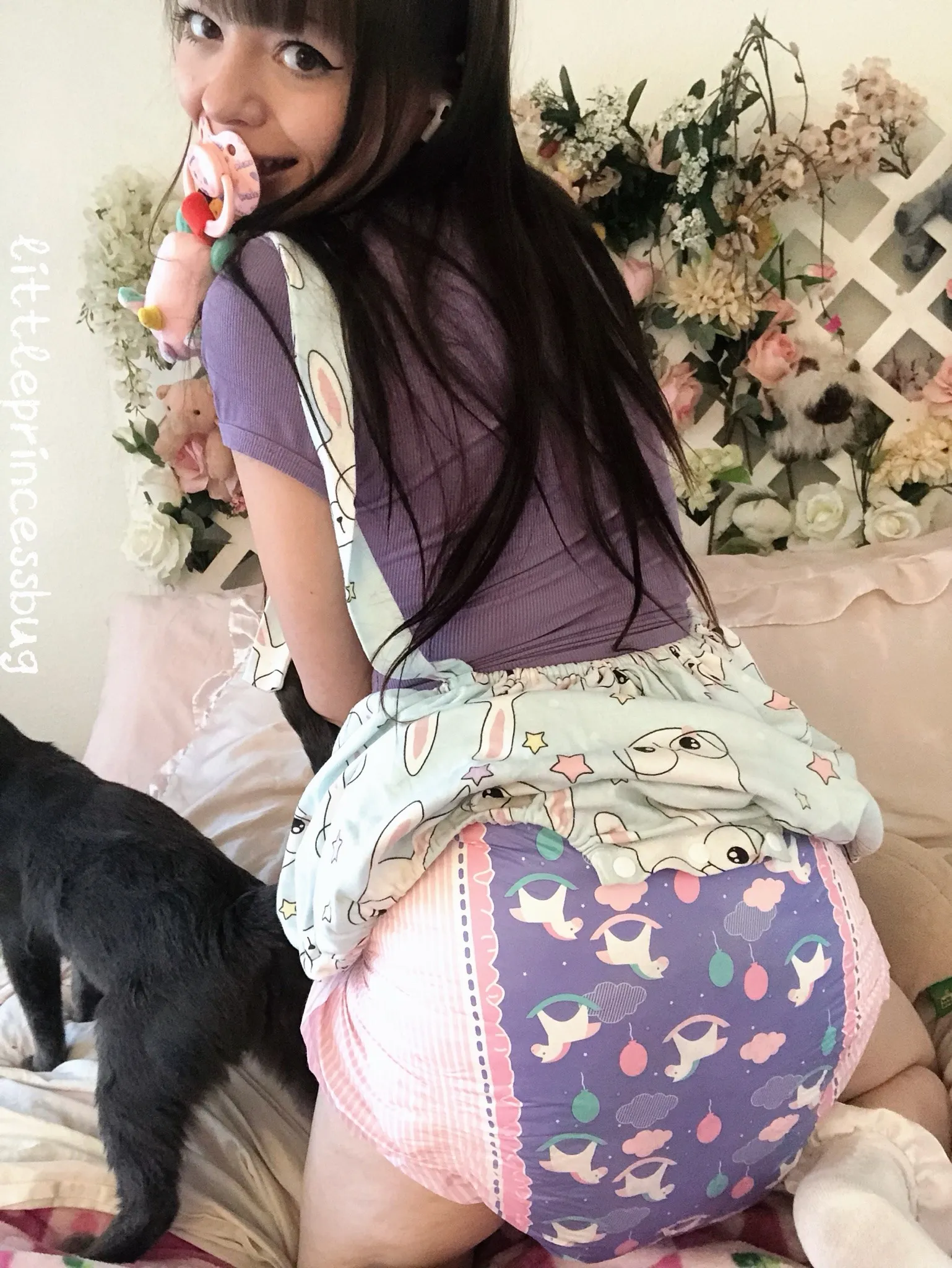 A large, round butt seen from behind, a girl wearing a cute horse-patterned diaper