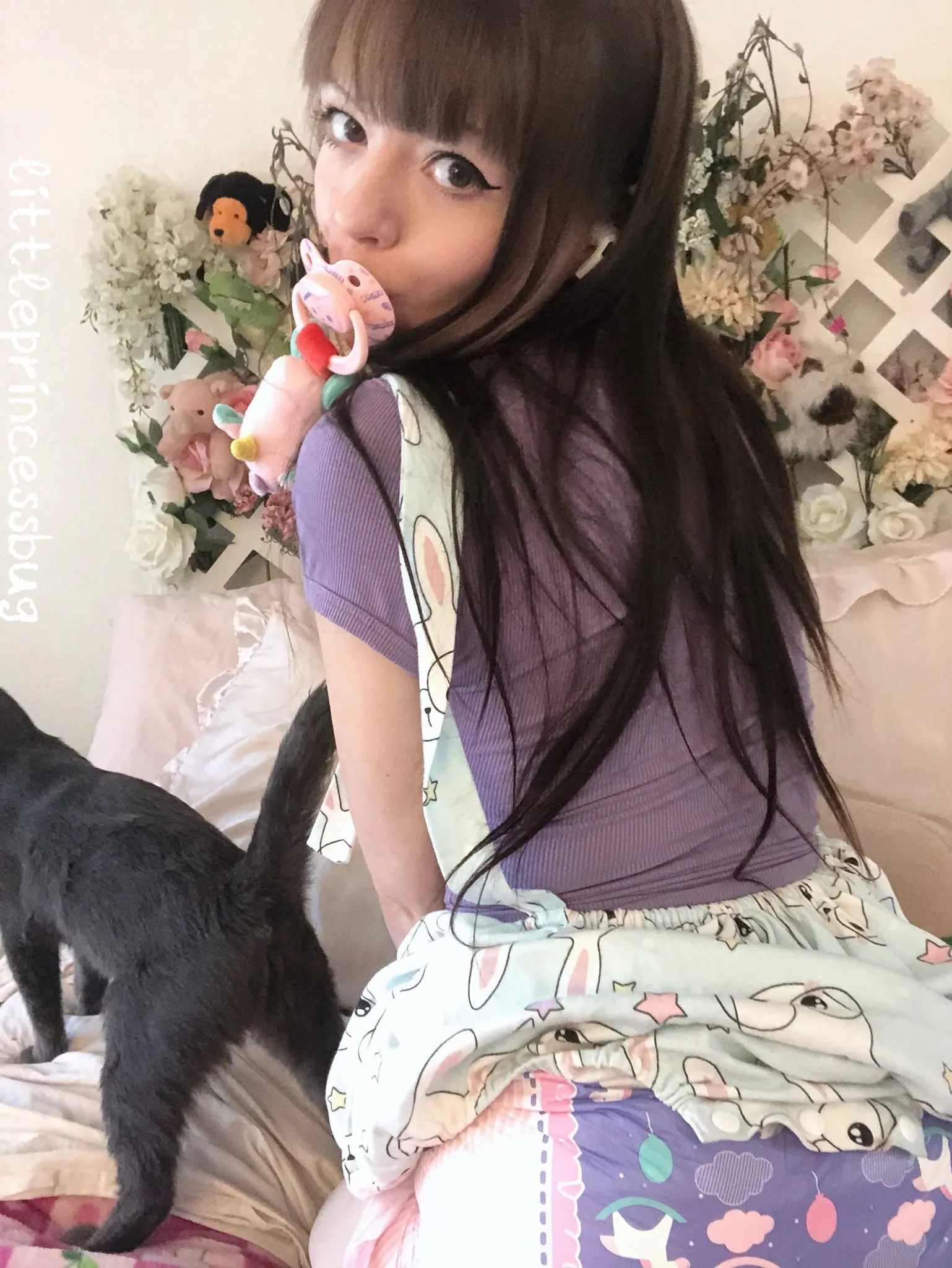 A girl with her thick purple diaper-clad bottom fully exposed from behind, her long hair flowing freely.